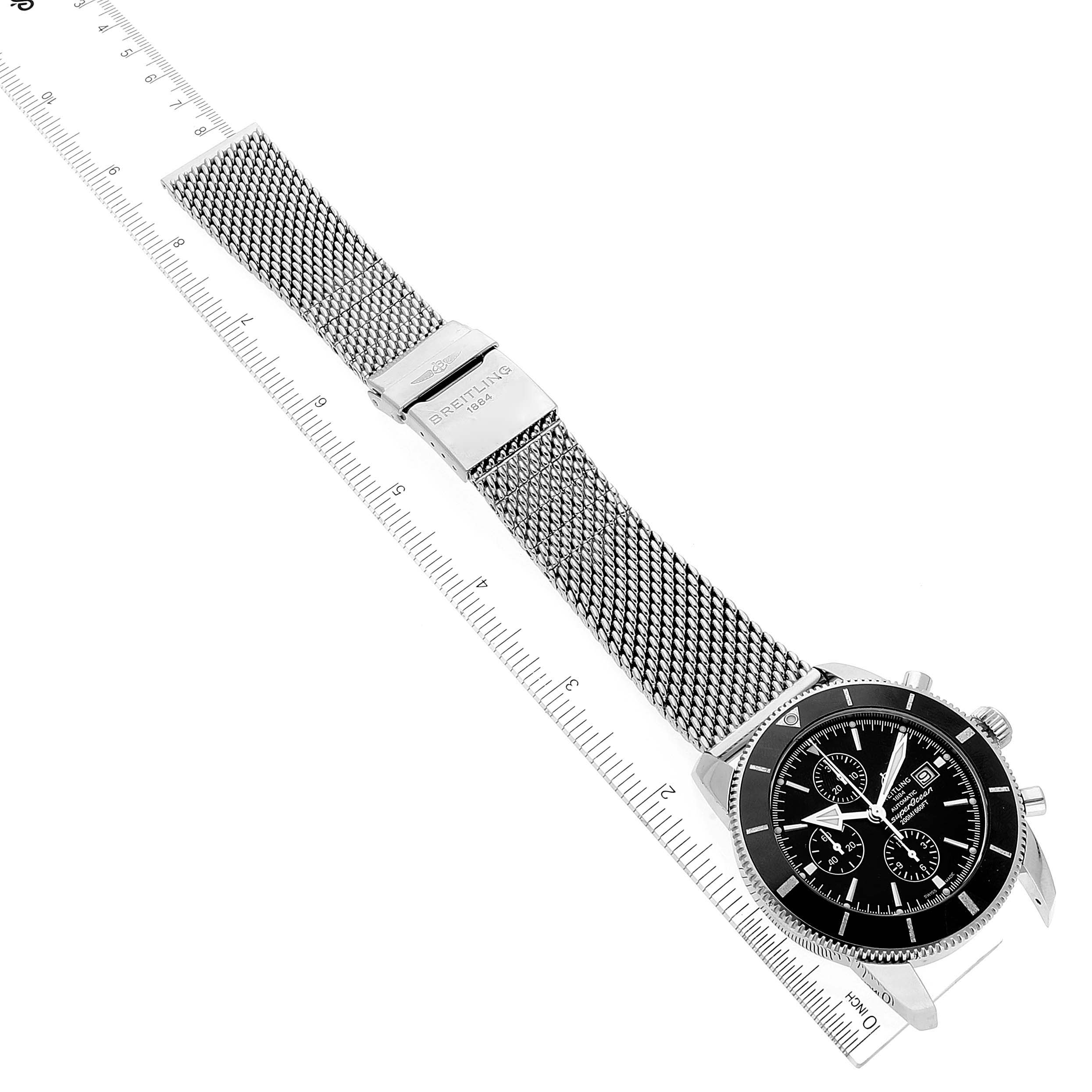 This image shows a Breitling Superocean A13312 Men's Stainless Steel Black Dial A13312 Men's Stainless Steel Black Dial watch, positioned flat with its metal mesh strap extended and a ruler placed alongside for scale.