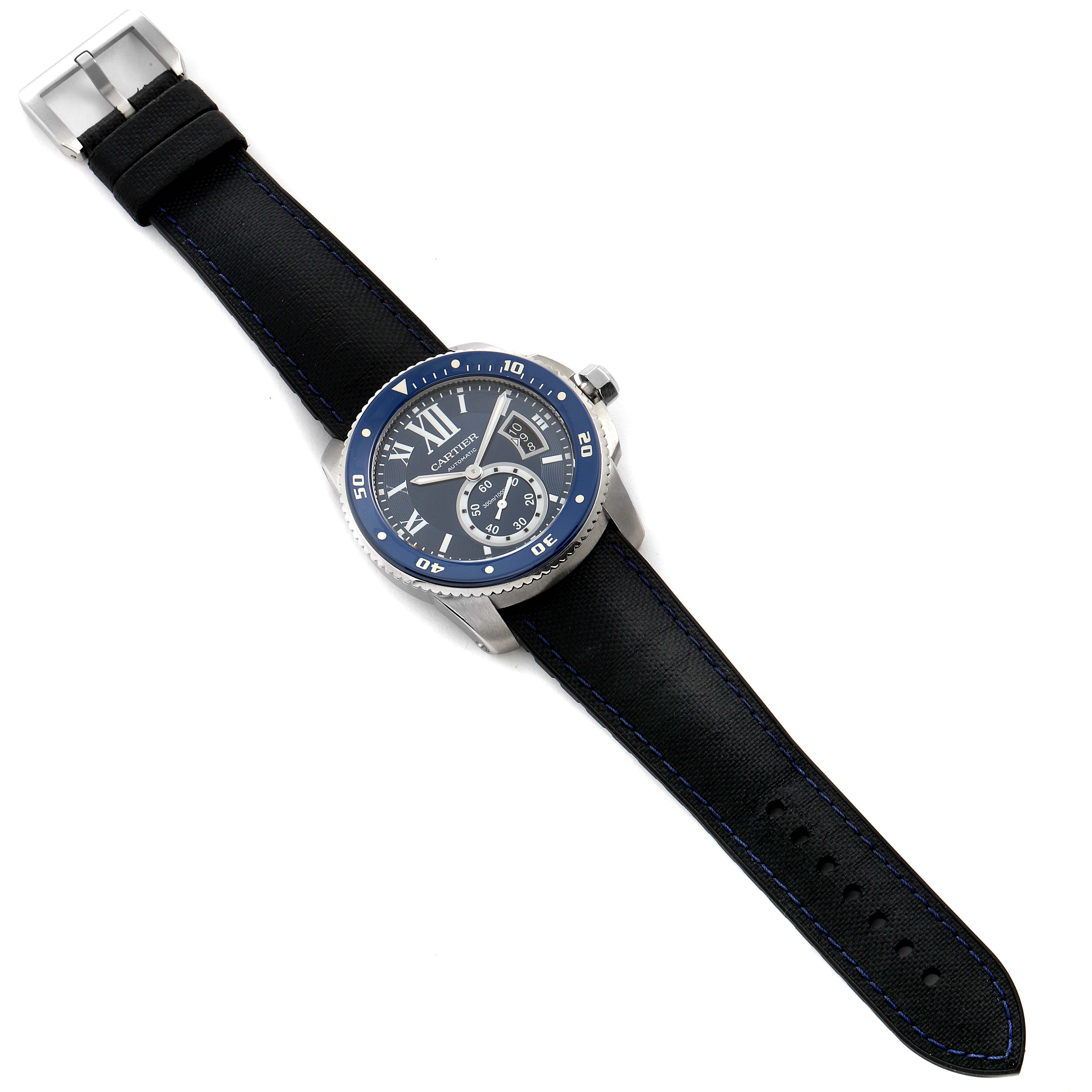 The image shows a top-down view of a Calibre de Cartier watch by Cartier, displaying the watch face, bezel, crown, and strap.