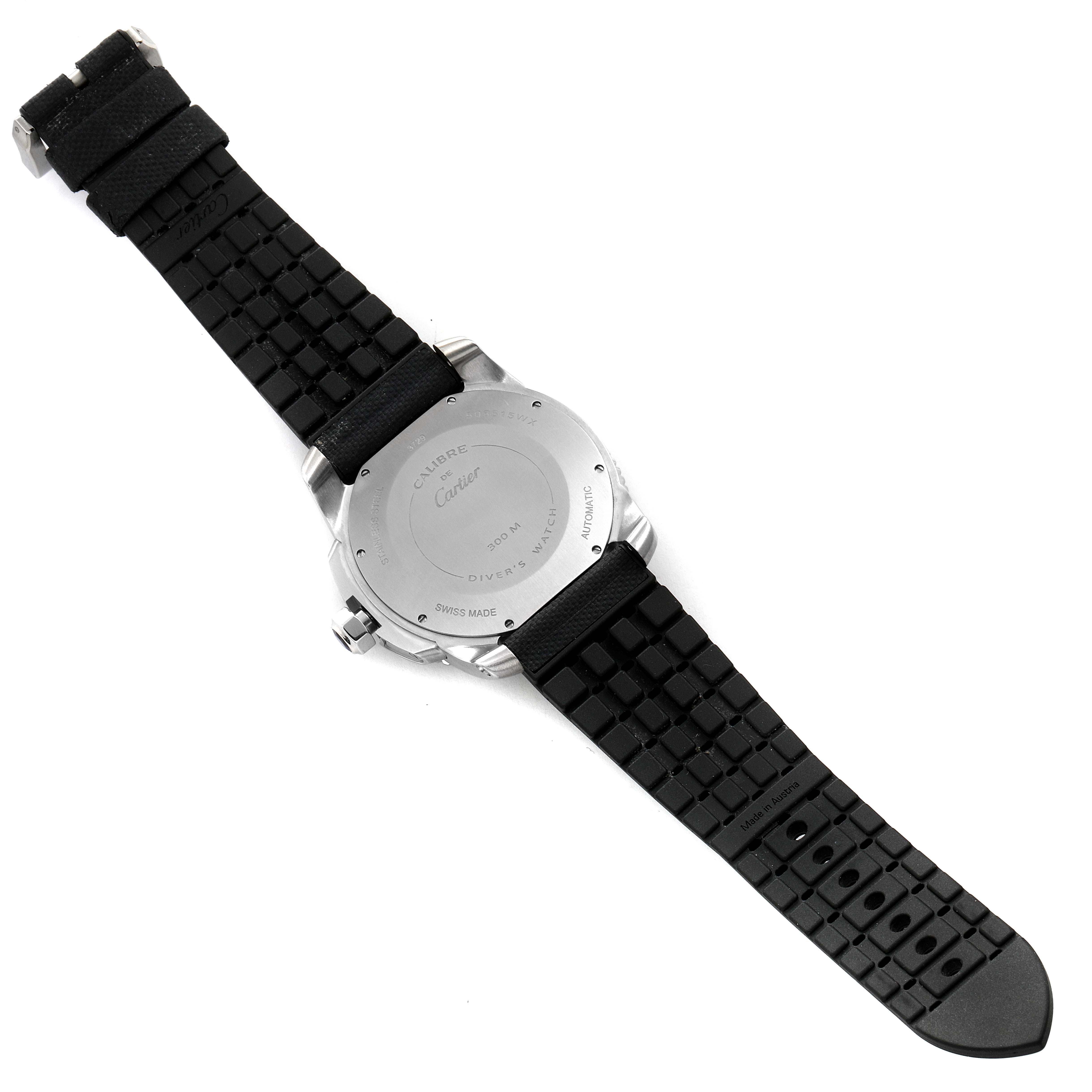 The image shows the back view of a Calibre de Cartier watch by Cartier, featuring its rubber strap and case back.