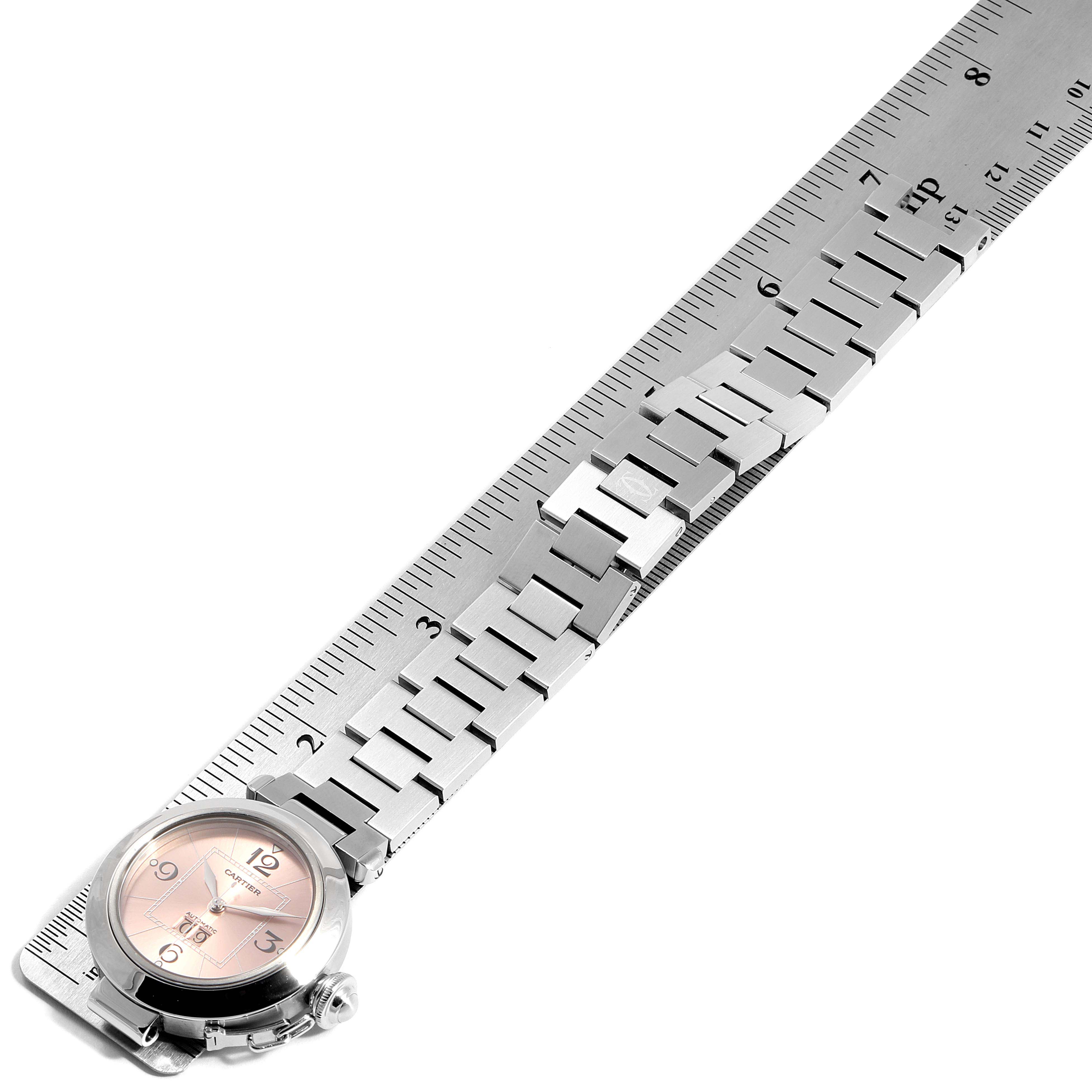 The image shows a top-down view of a Cartier Pasha W31058M7 Women
s Stainless Steel Pink Dial W31058M7 Women
s Stainless Steel Pink Dial watch, including the face and stainless steel bracelet.