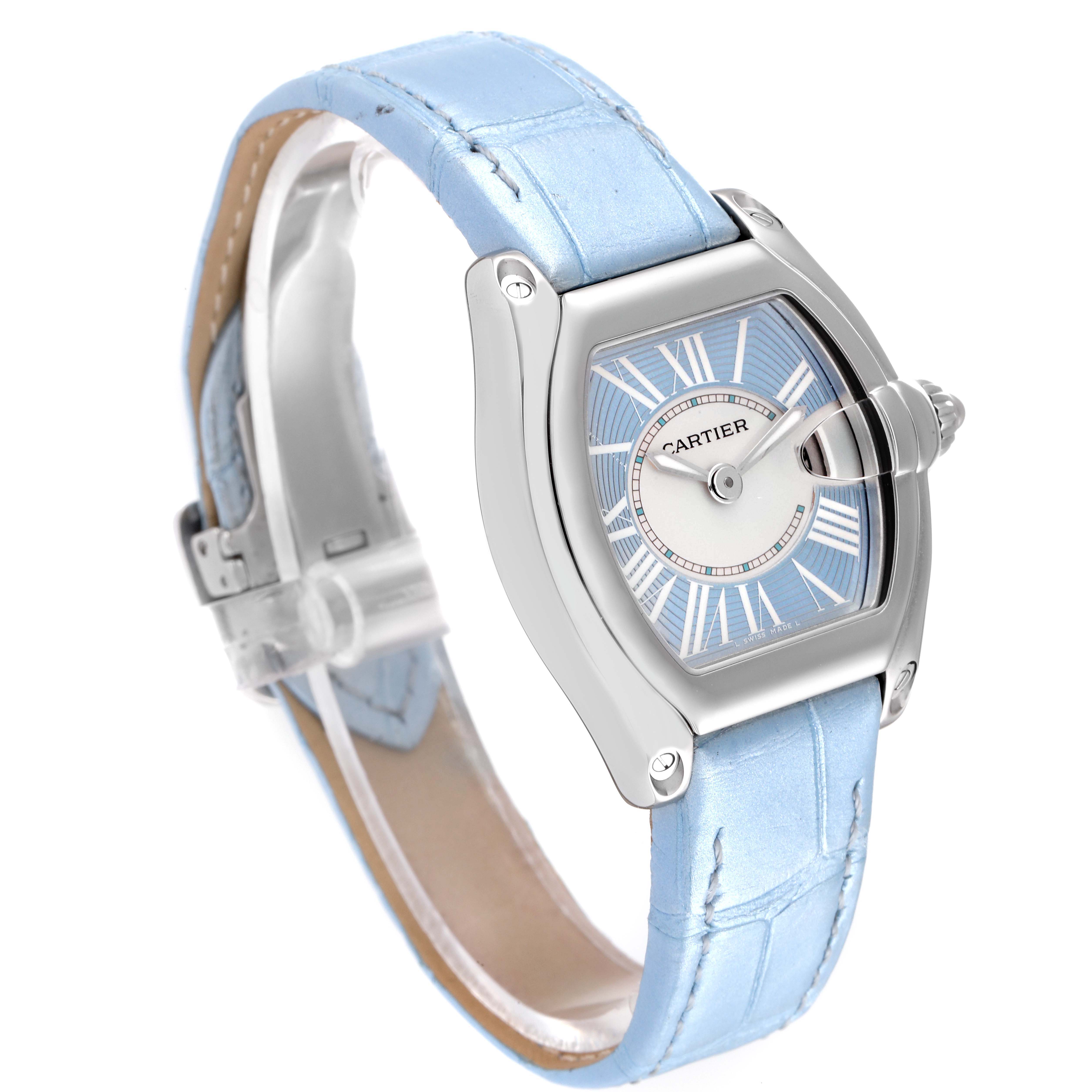 The Cartier Roadster W62053V3 Women's Stainless Steel Blue Dial W62053V3 Women's Stainless Steel Blue Dial watch is shown at a three-quarter angle, highlighting its face, case, and light blue strap.