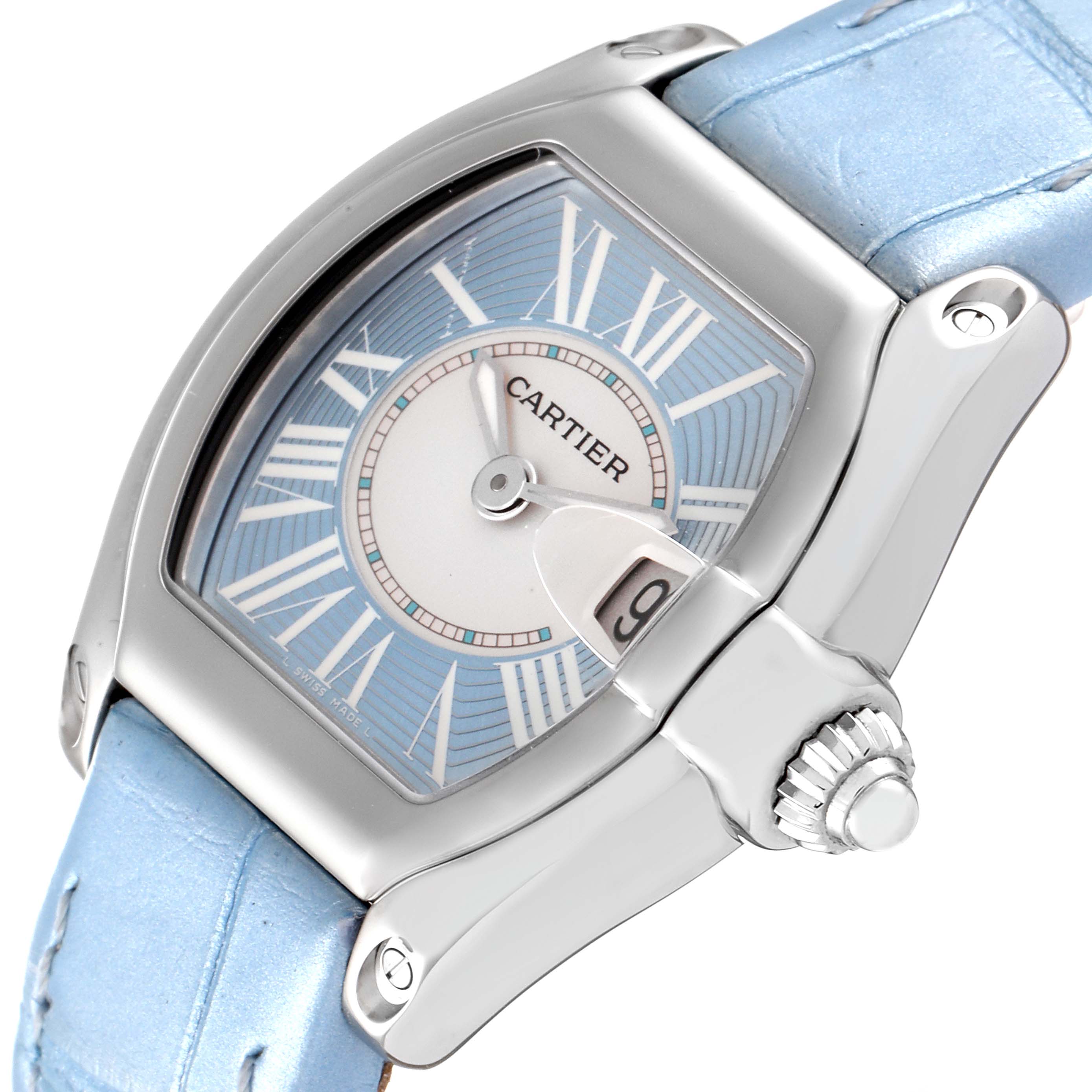 The image shows a Cartier Roadster W62053V3 Women's Stainless Steel Blue Dial W62053V3 Women's Stainless Steel Blue Dial watch from a tilted angle, featuring its dial, crown, and part of its light blue strap.