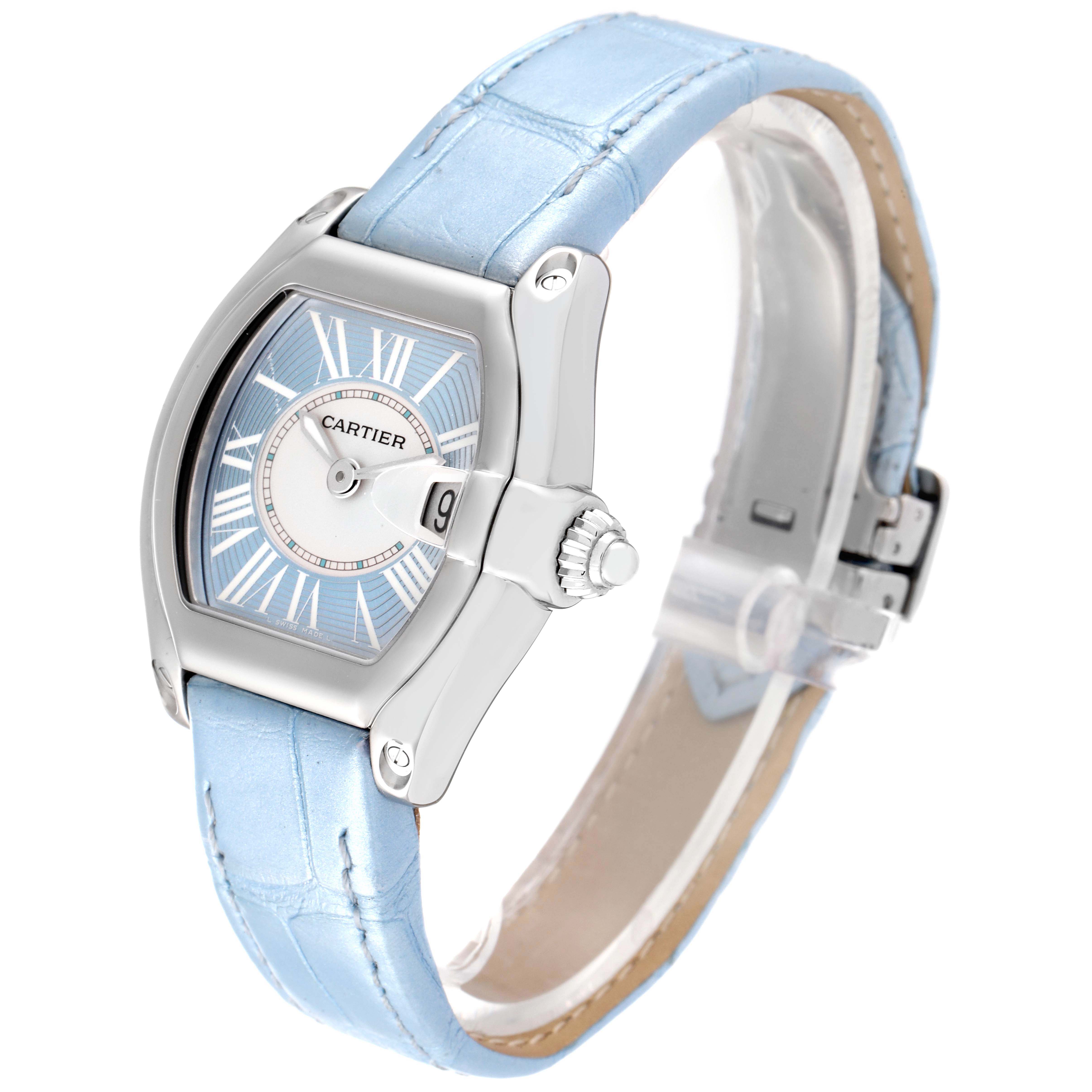 The image shows a Cartier Roadster W62053V3 Women's Stainless Steel Blue Dial W62053V3 Women's Stainless Steel Blue Dial watch at a three-quarter angle, highlighting the face, crown, and light blue strap.