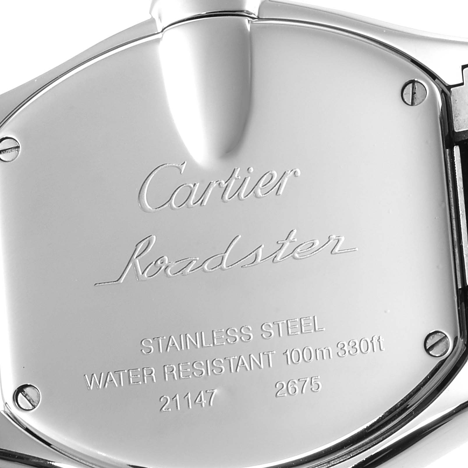 Close-up view of the case back of the Cartier Roadster W62053V3 Women's Stainless Steel Blue Dial W62053V3 Women's Stainless Steel Blue Dial watch, showing engraved details and screws.