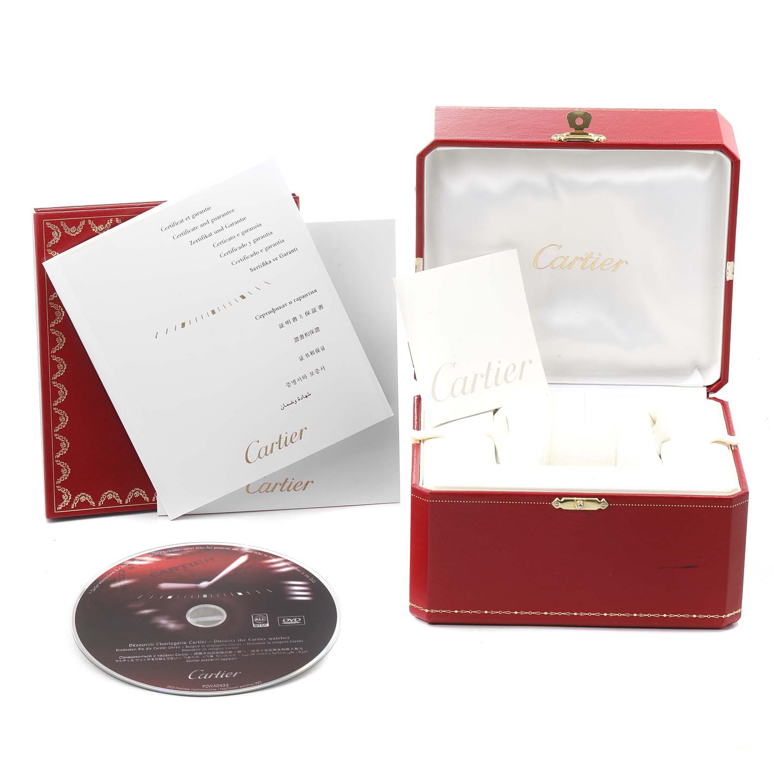 The image shows an open Cartier Roadster W62019X6 Men
s Stainless Steel Silver Dial W62019X6 Men
s Stainless Steel Silver Dial watch box, warranty booklets, and a CD arranged side by side.