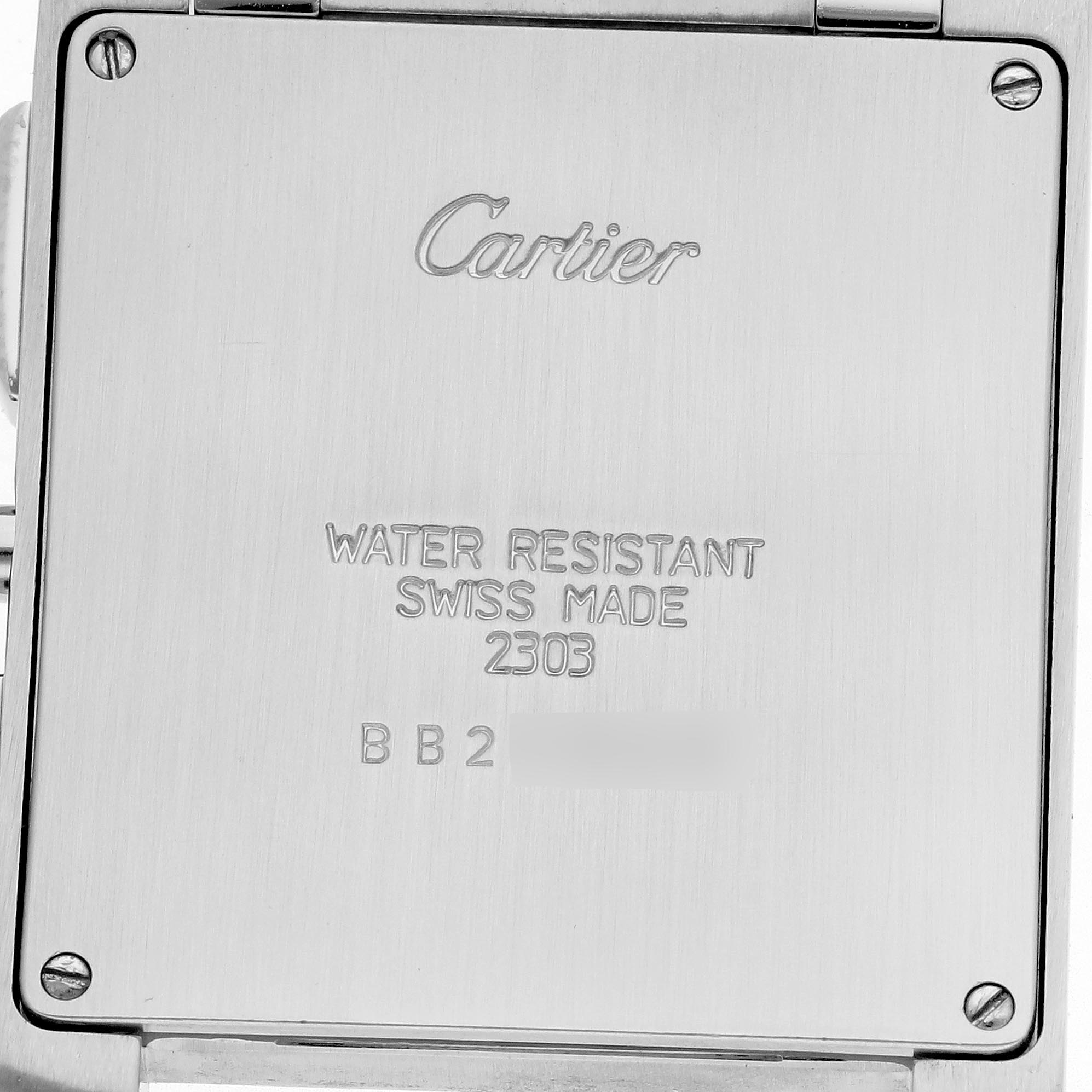 The image shows the back of a Cartier Tank Française watch, featuring engraved text and screws.