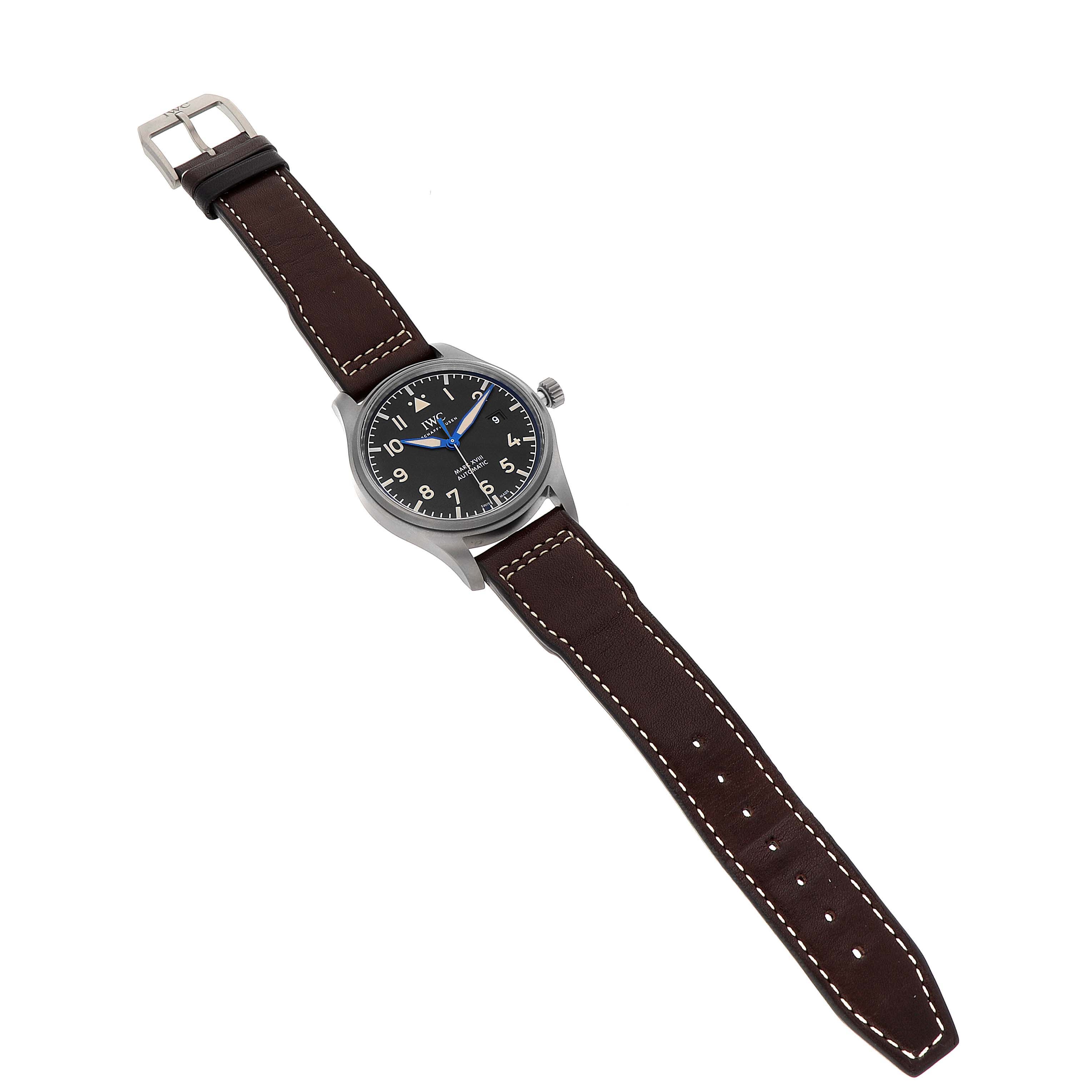 The IWC Pilot IW327006 Men's Titanium Black Dial IW327006 Men's Titanium Black Dial watch is shown from a top-down angle, featuring a black dial, brown leather strap, and stainless steel case.