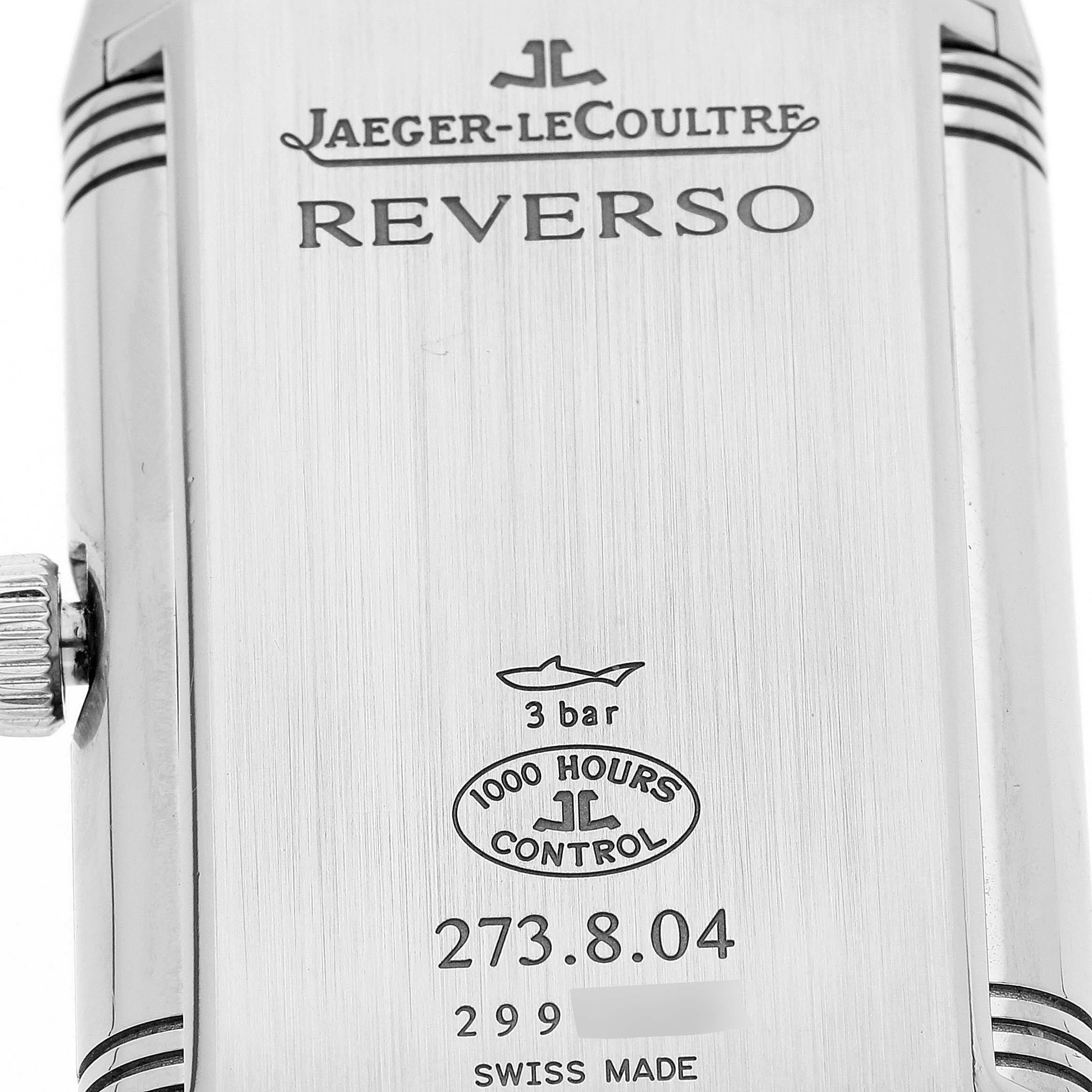 The image shows the back casing of a Jaeger-LeCoultre Reverso watch, including branding, model number, and other specifications.