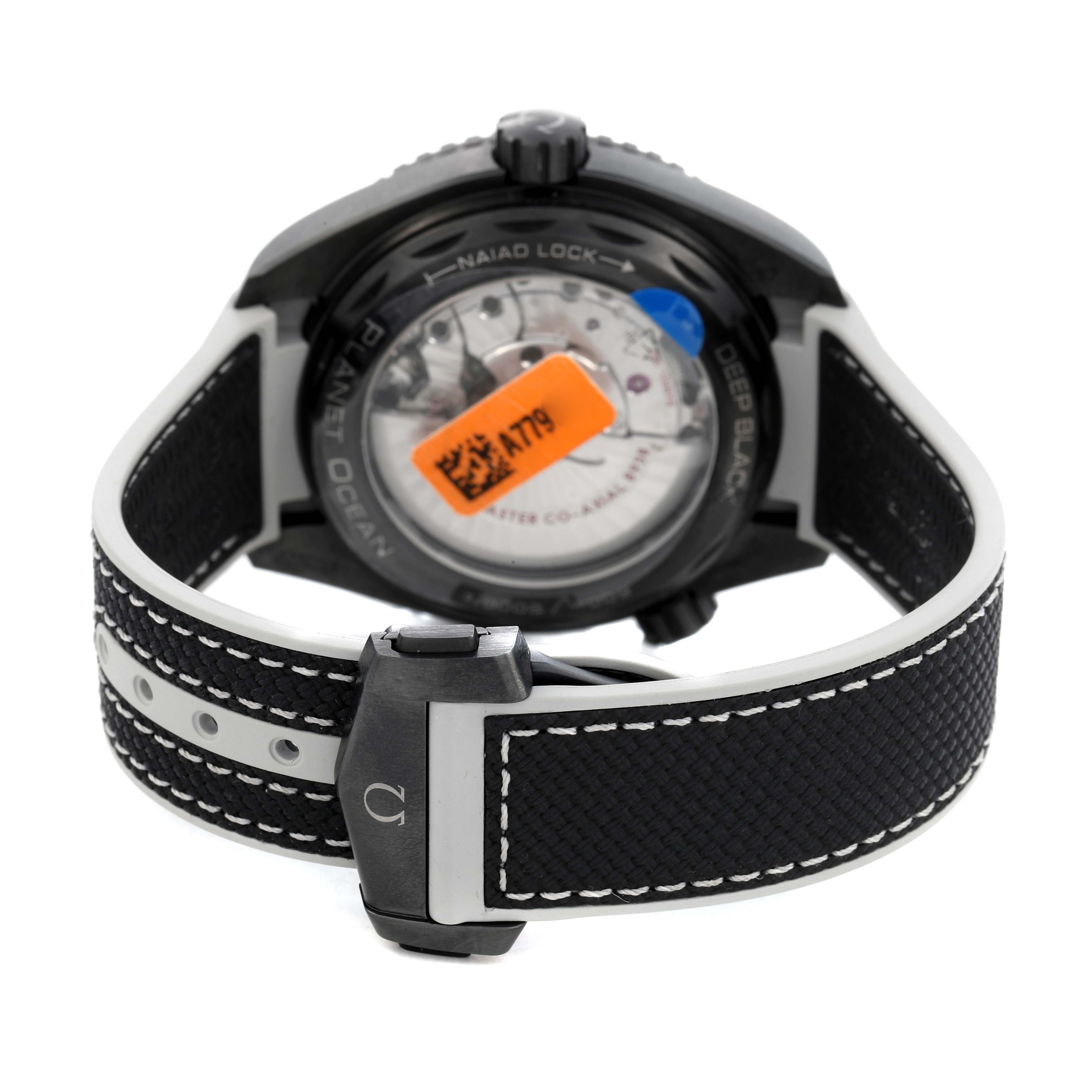 The Omega Planet Ocean 215.92.46.22.01.007 Men's Ceramic Black Dial watch is shown from the back, highlighting its strap, clasp, and transparent case back.