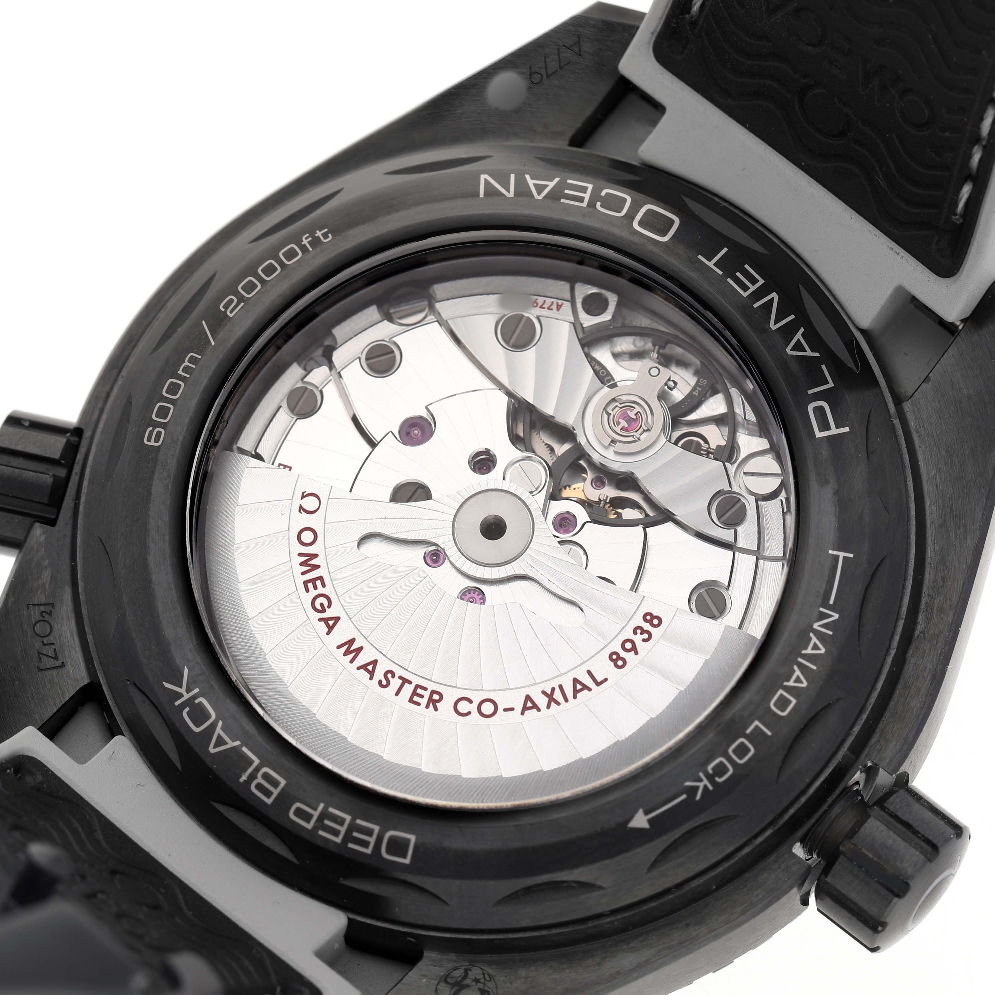 The image shows the back case of an Omega Planet Ocean 215.92.46.22.01.007 Men's Ceramic Black Dial watch, highlighting the Co-Axial movement and inner mechanics.