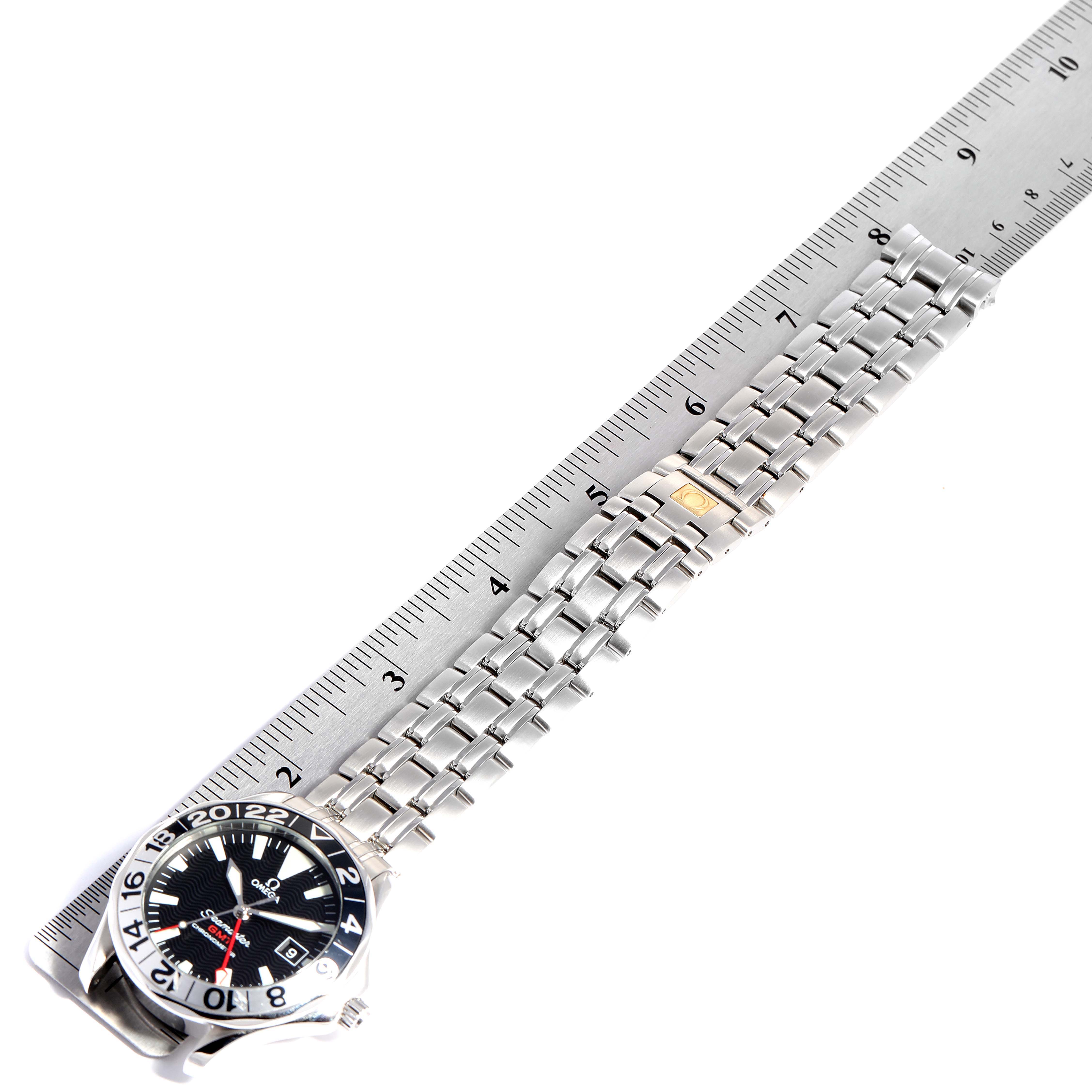 This image shows the Omega Seamaster 2534.50.00 Men
s Stainless Steel Black Dial 2534.50.00 Men
s Stainless Steel Black Dial watch at a top-down angle, including part of the bracelet and a ruler for scale.