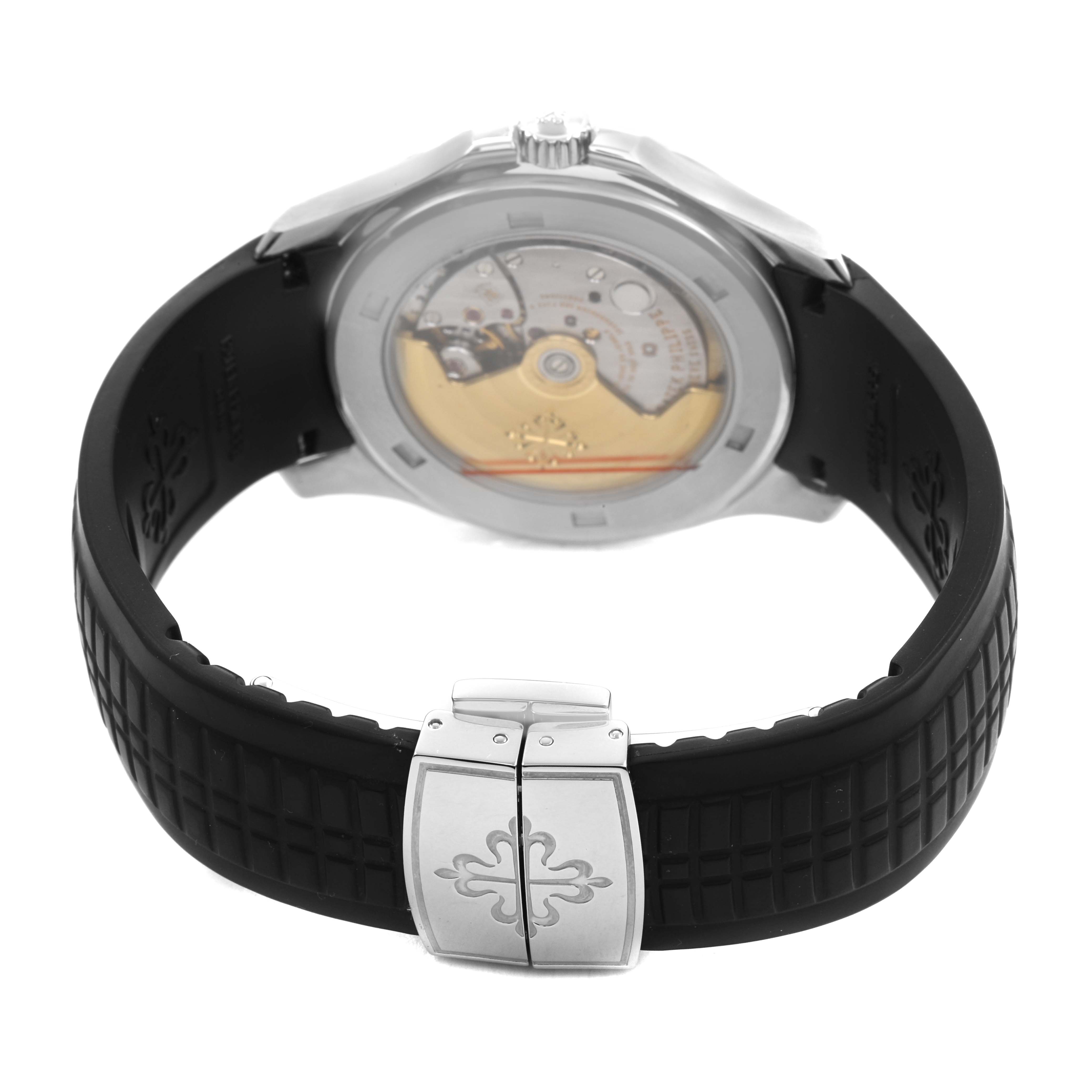 The image shows the back view of the Patek Philippe Aquanaut 5165A-001 Men's Stainless Steel Black Dial watch, revealing the movement and clasp on the rubber strap.