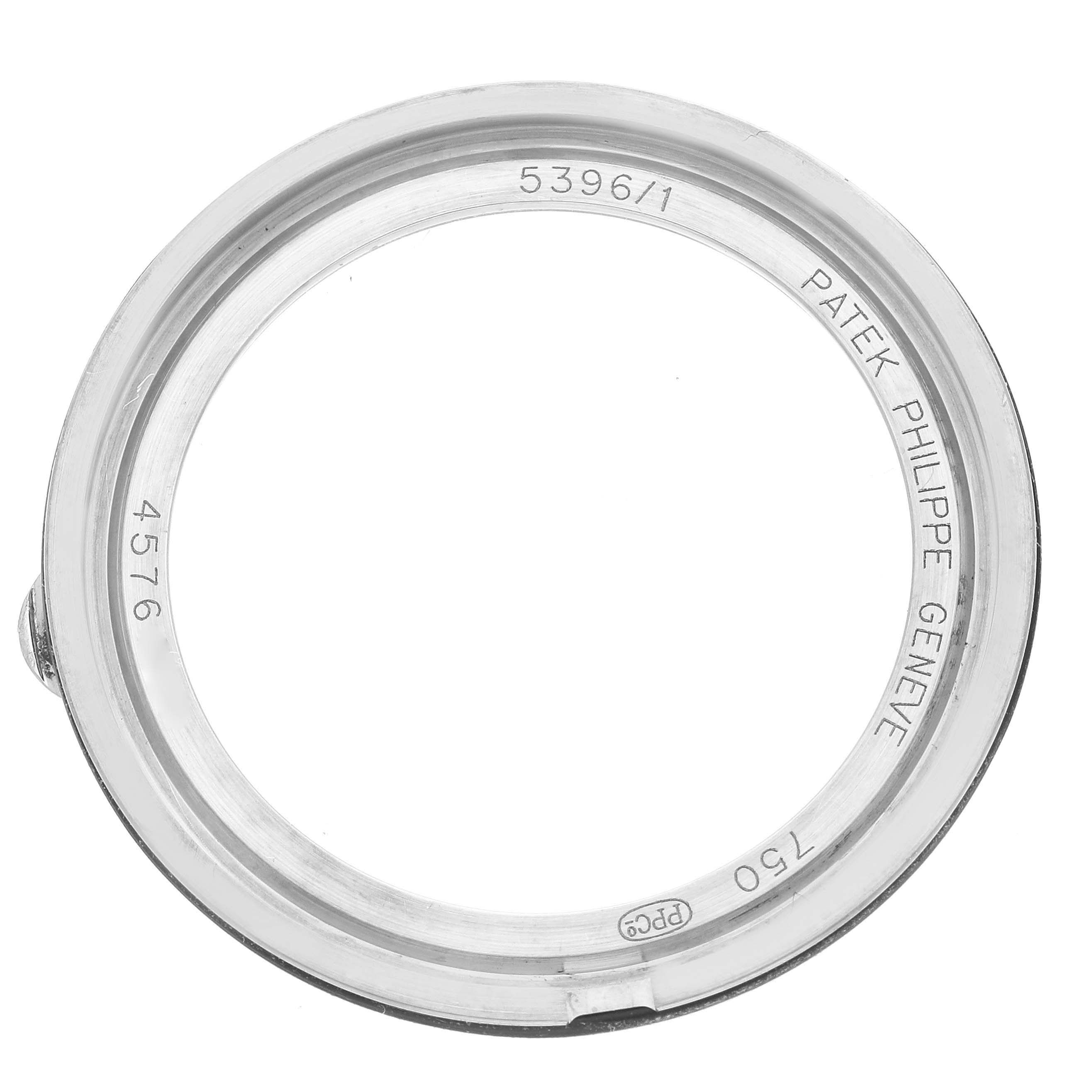 The image shows a case back for the Patek Philippe Complications 5396/1G-001 Men
s White Gold Blue Dial 5396/1G-001 Men
s White Gold Blue Dial model viewed from above, displaying engravings and a clear center.