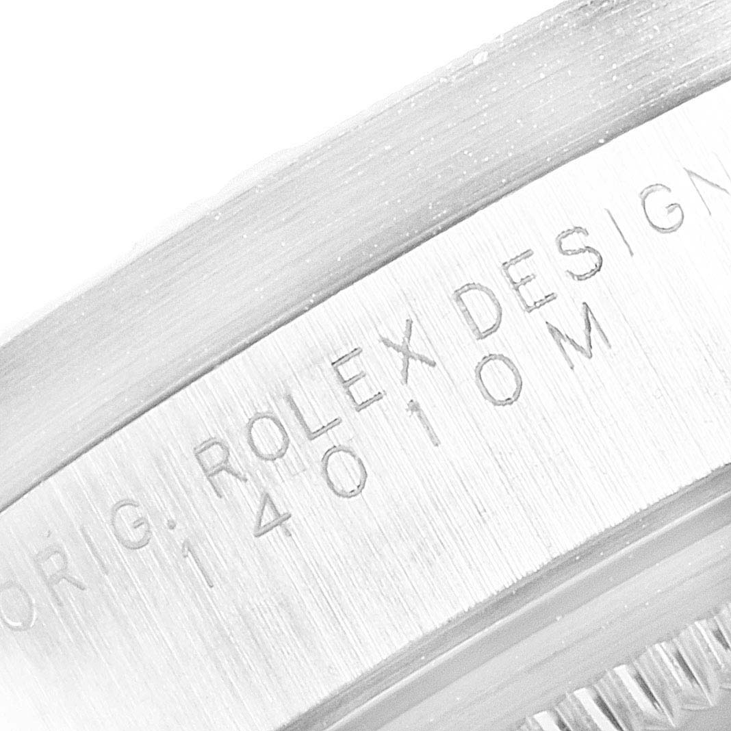 A close-up of the side of a Rolex Air-King 14010 Men's Stainless Steel Black Dial 14010 Men's Stainless Steel Black Dial watch, showing engraved "ROLEX DESIGN" and model number.