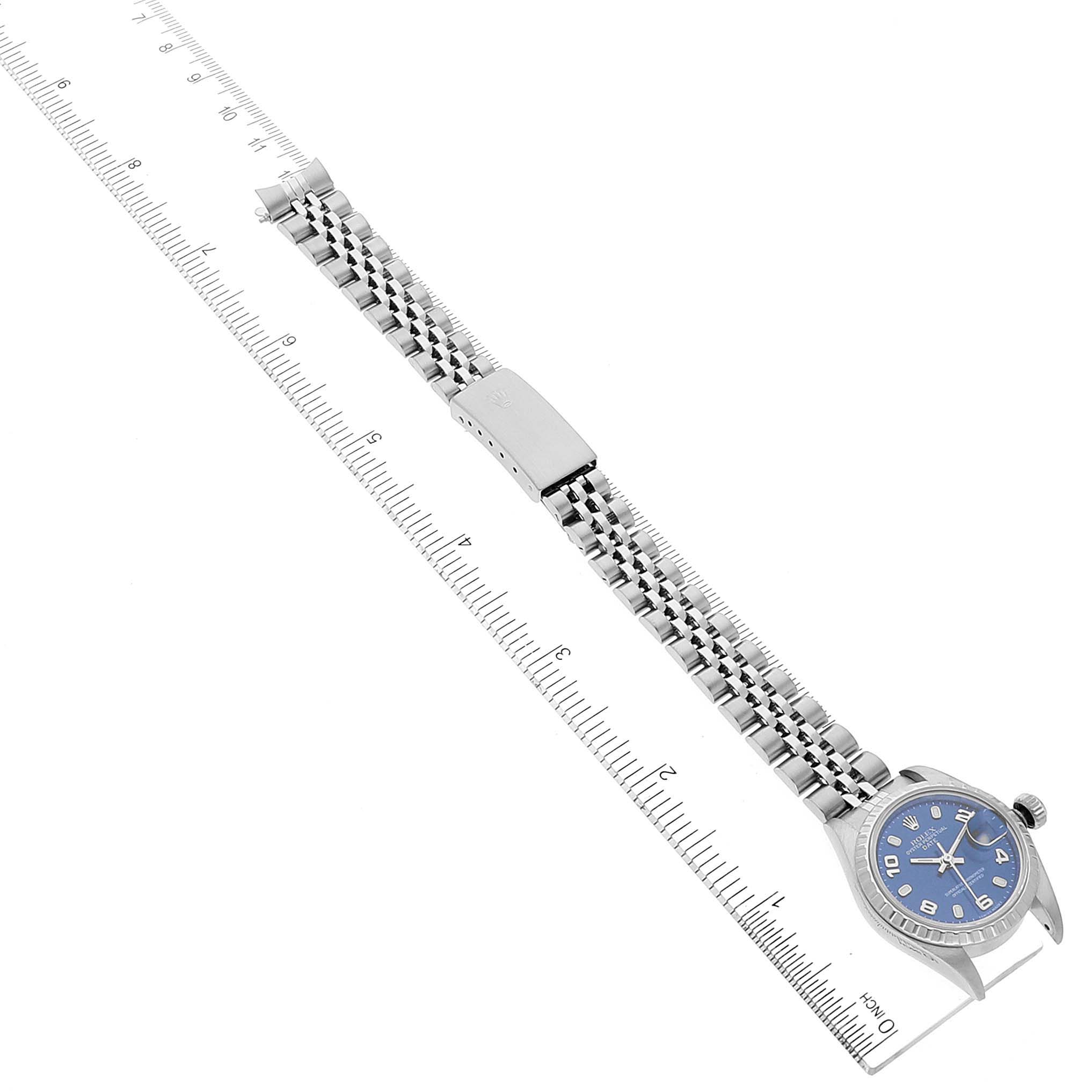 The image shows a top-down view of a Rolex Date 79240 Women
s Stainless Steel Blue Dial 79240 Women
s Stainless Steel Blue Dial model watch, featuring its blue dial, bracelet band, and folding clasp.
