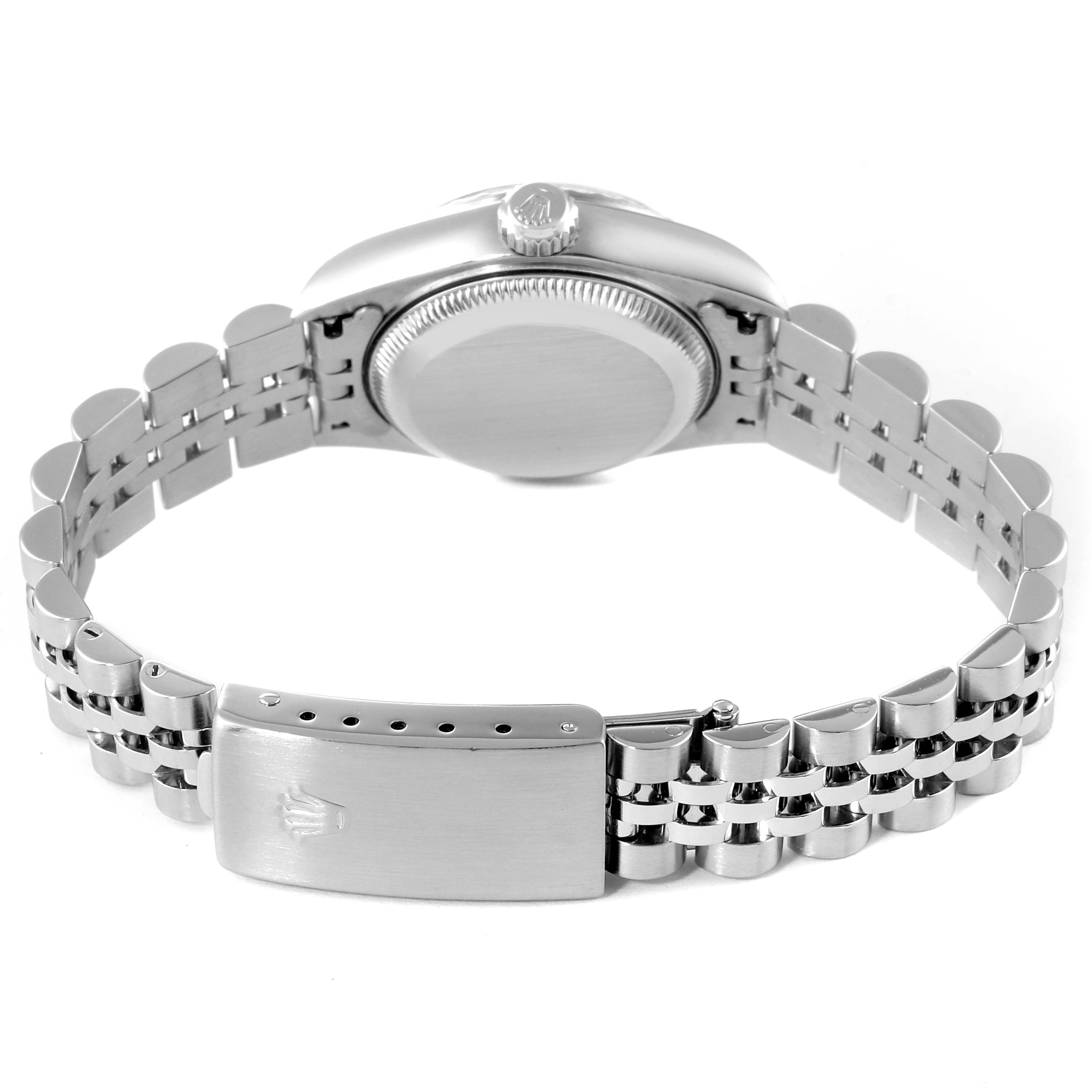 The image shows the back case and bracelet clasp of a Rolex Date 79240 Women
s Stainless Steel Blue Dial 79240 Women
s Stainless Steel Blue Dial model watch from a side angle.