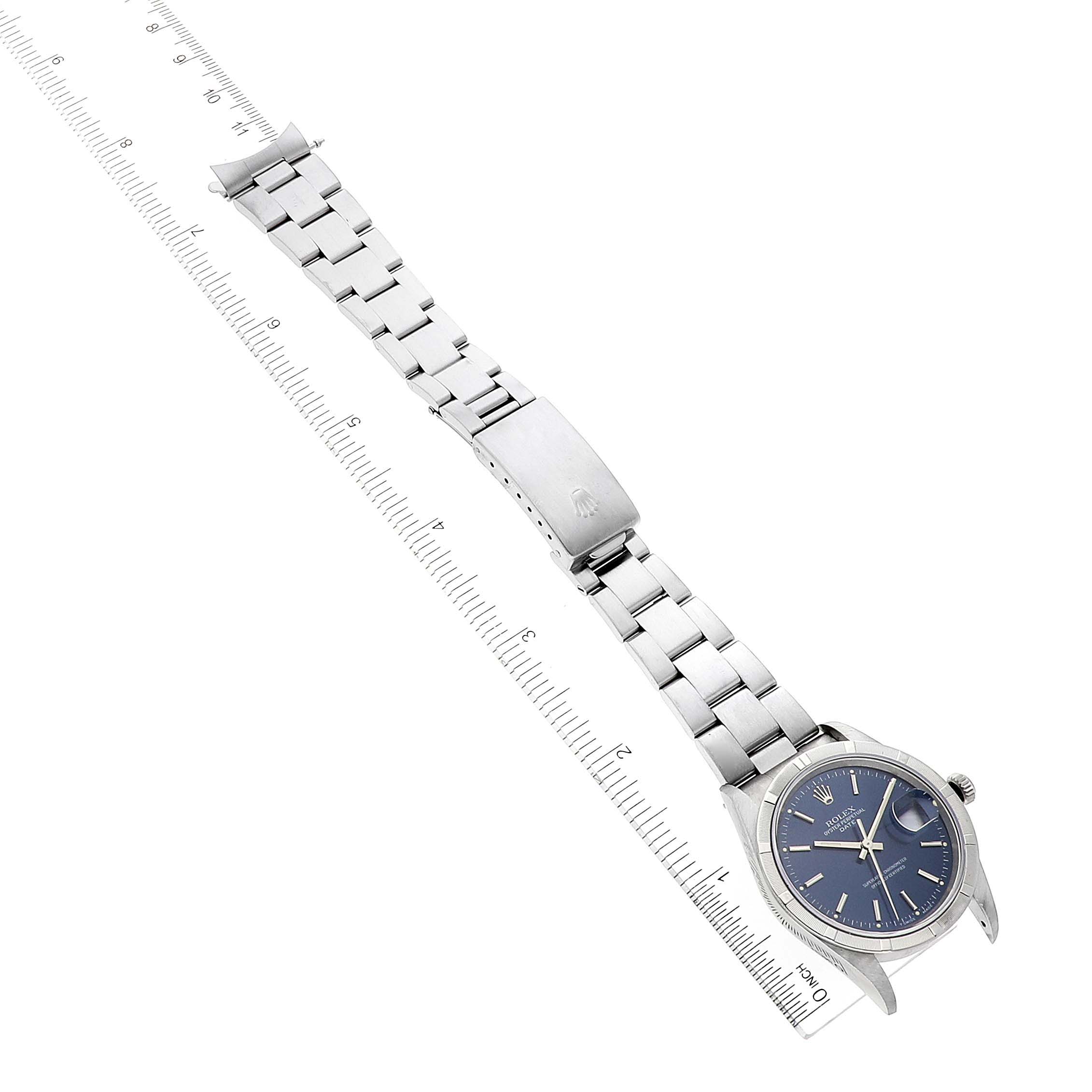 The Rolex Date 15210 Men's Stainless Steel Blue Dial 15210 Men's Stainless Steel Blue Dial model watch is shown laid flat with its bracelet fully extended and a ruler for scale.