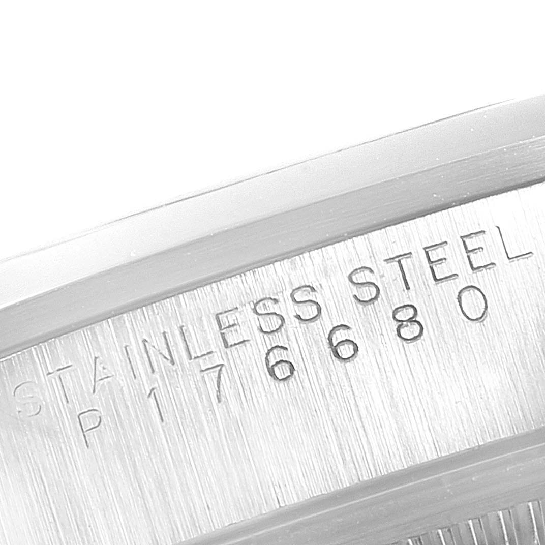 The image shows a close-up view of the serial number and "Stainless Steel" engraving on the case back of a Rolex Date 15200 Men's Stainless Steel Silver Dial 15200 Men's Stainless Steel Silver Dial model.