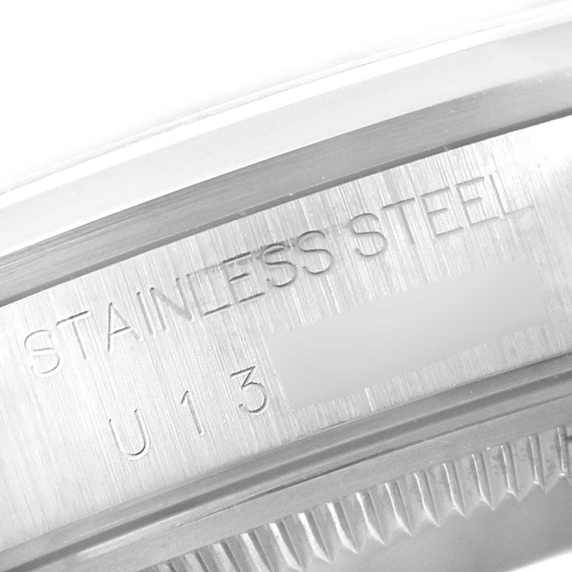 This close-up angle shows the engraved text on the side of the stainless steel case of a Rolex Date 15200 Men's Stainless Steel White Dial 15200 Men's Stainless Steel White Dial model watch.