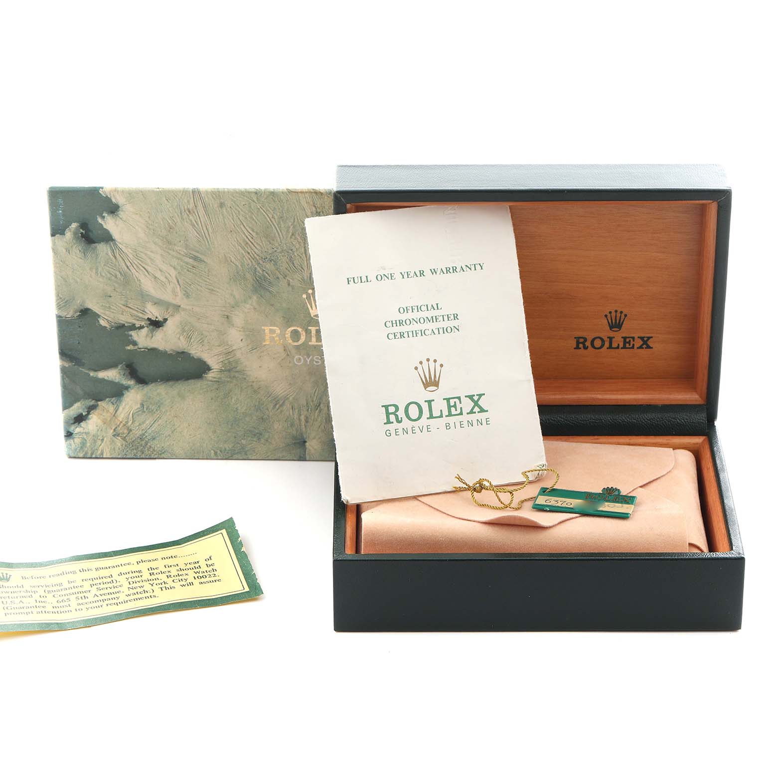 The image shows the packaging and certification for a Rolex Date model watch, including the box, warranty, and tag.