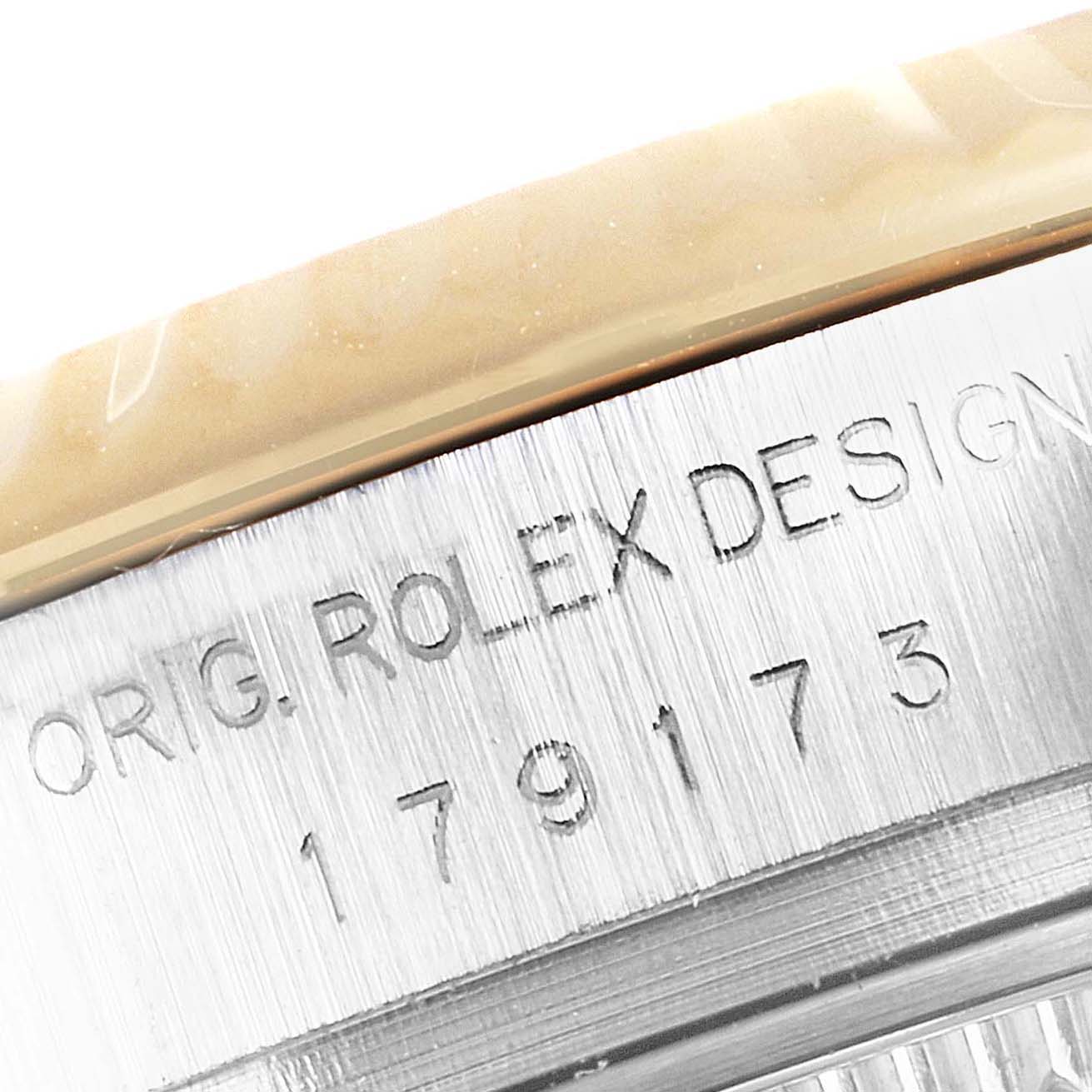 The image shows a close-up of the model number engraved on the side of a Rolex Datejust 179173 Women
s Steel and Gold (two tone) Champagne Dial 179173 Women
s Steel and Gold (two tone) Champagne Dial watch case.