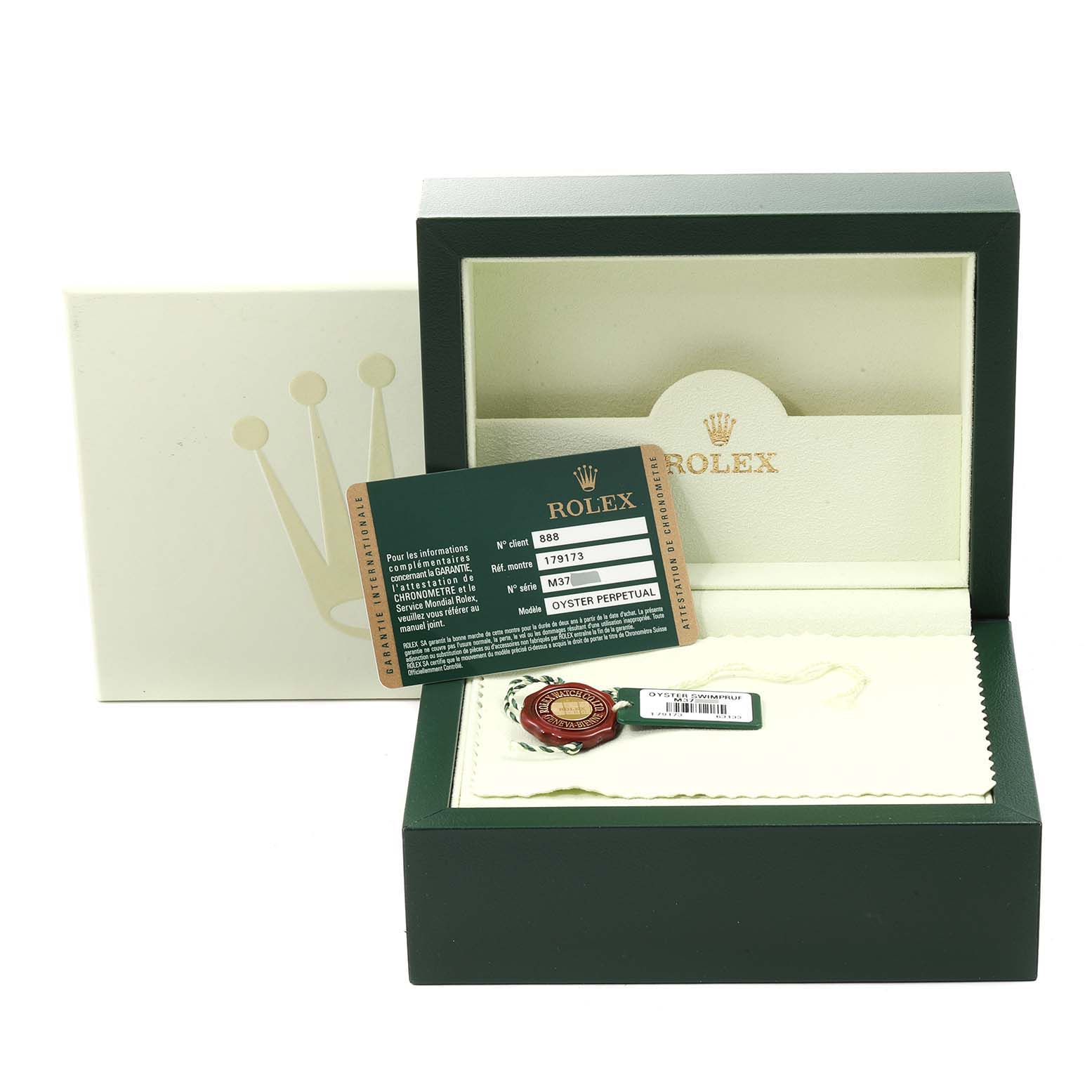 The image shows the accessories of a Rolex Datejust 179173 Women
s Steel and Gold (two tone) Champagne Dial 179173 Women
s Steel and Gold (two tone) Champagne Dial, including the box, warranty card, and tags, viewed from the front.