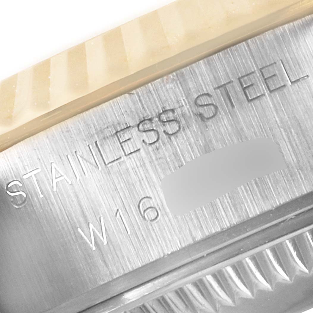 The image shows a close-up of the side of a stainless steel Rolex Datejust 69173 Women
s Steel and Gold (two tone) Champagne Dial 69173 Women
s Steel and Gold (two tone) Champagne Dial, highlighting the engraved text.