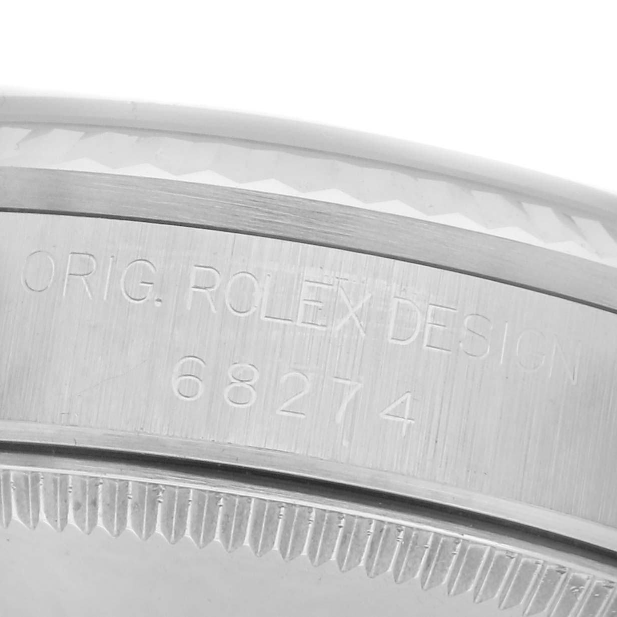 The image shows a close-up of the case edge of a mid-size Rolex watch, revealing the model number and “Orig. Rolex Design” engraving.