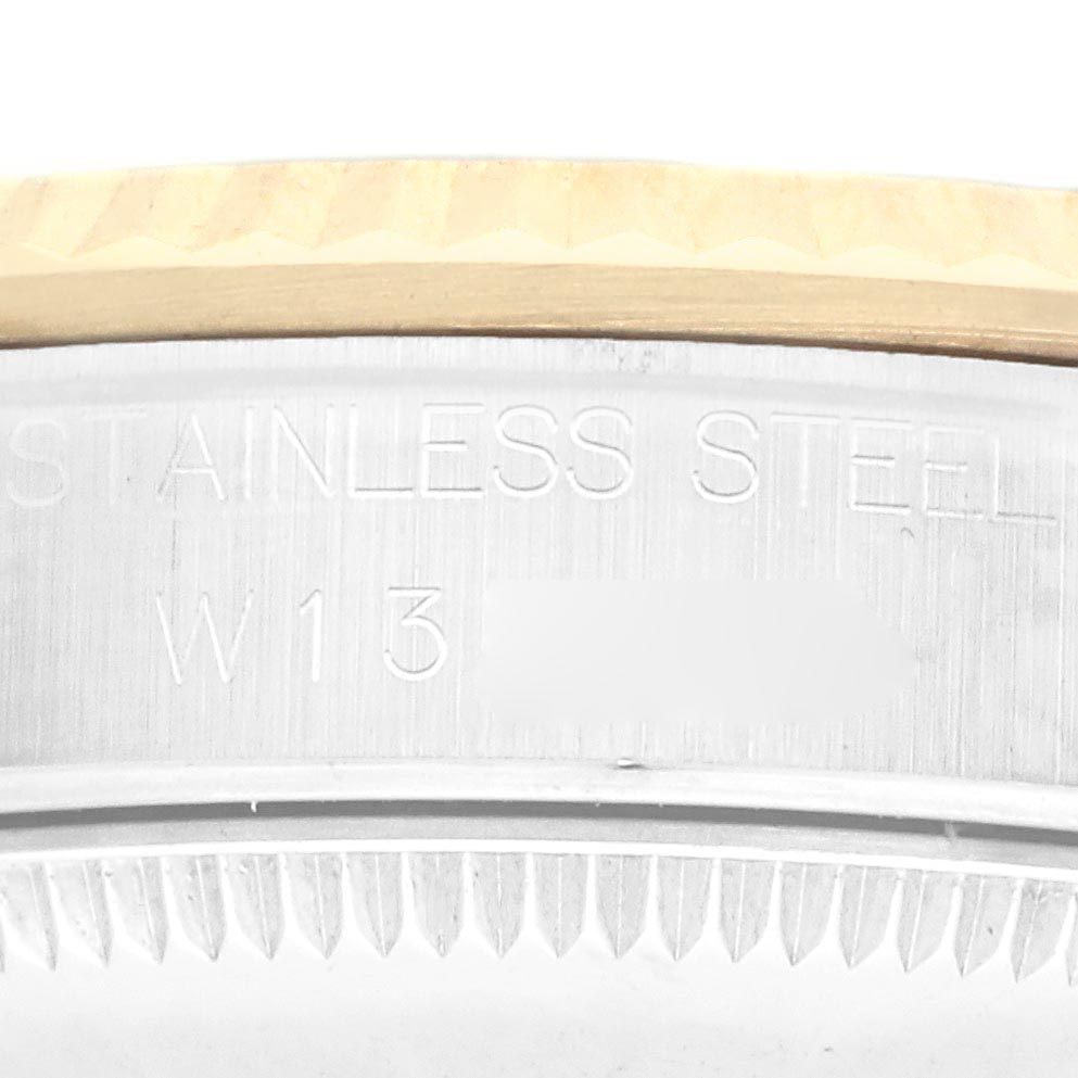 The image features the side profile of a mid-size Rolex watch, focusing on the stainless steel case with visible engraving.