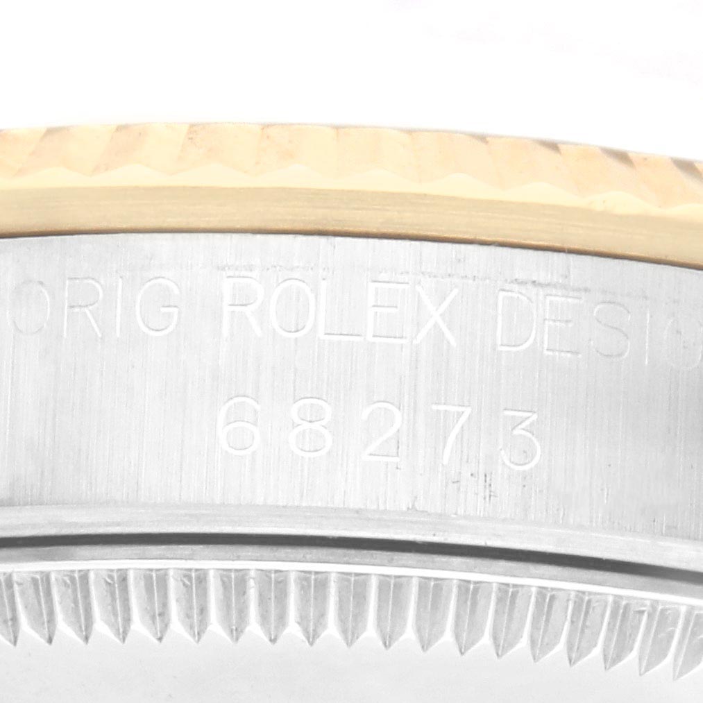 The image shows a close-up of the side of a Rolex Mid-Size 68273 Women's Steel and Gold (two tone) White Dial 68273 Women's Steel and Gold (two tone) White Dial watch, highlighting the engraved serial number and bezel edge.