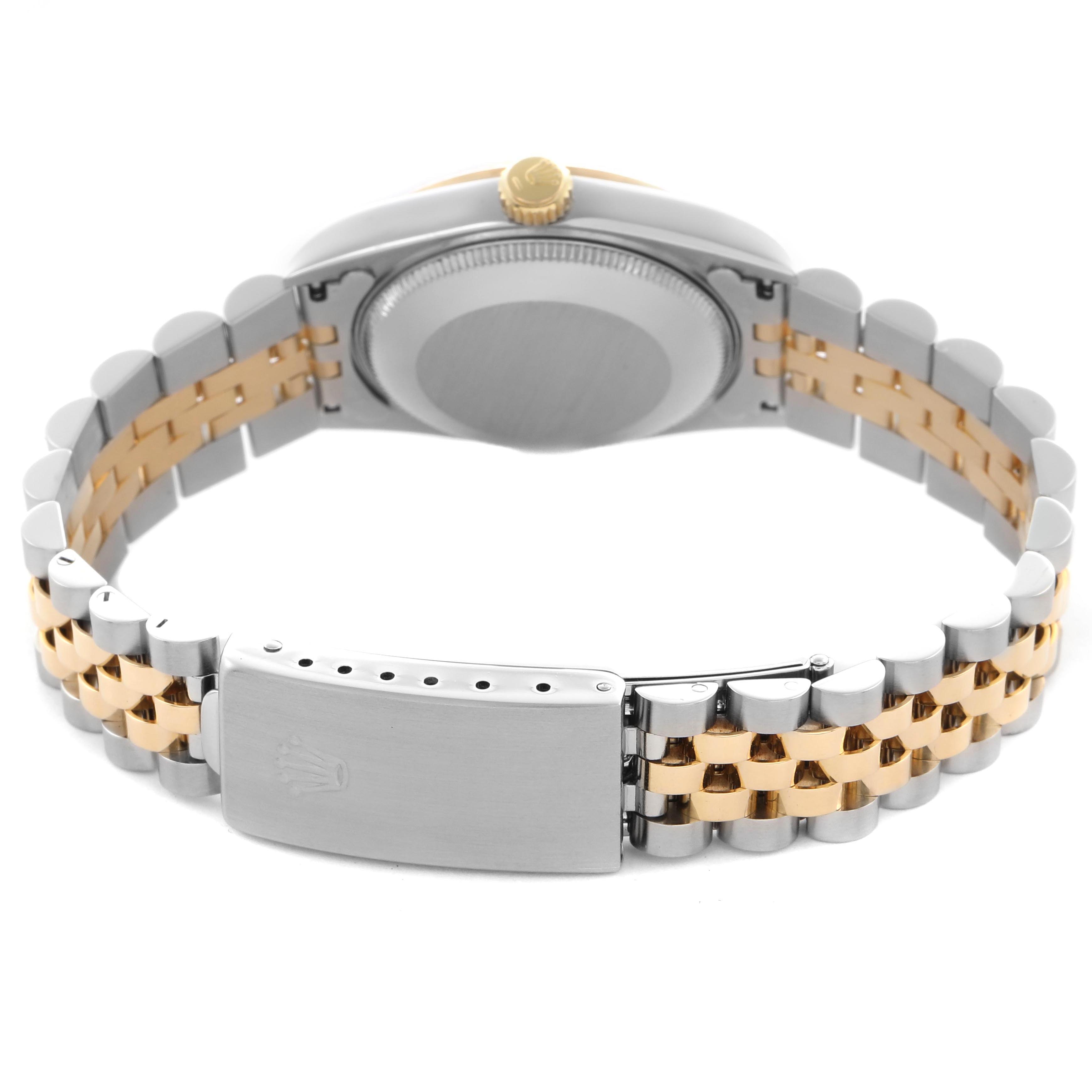 The Mid-Size Rolex watch is shown from the back, displaying the case, crown, and bracelet clasp.