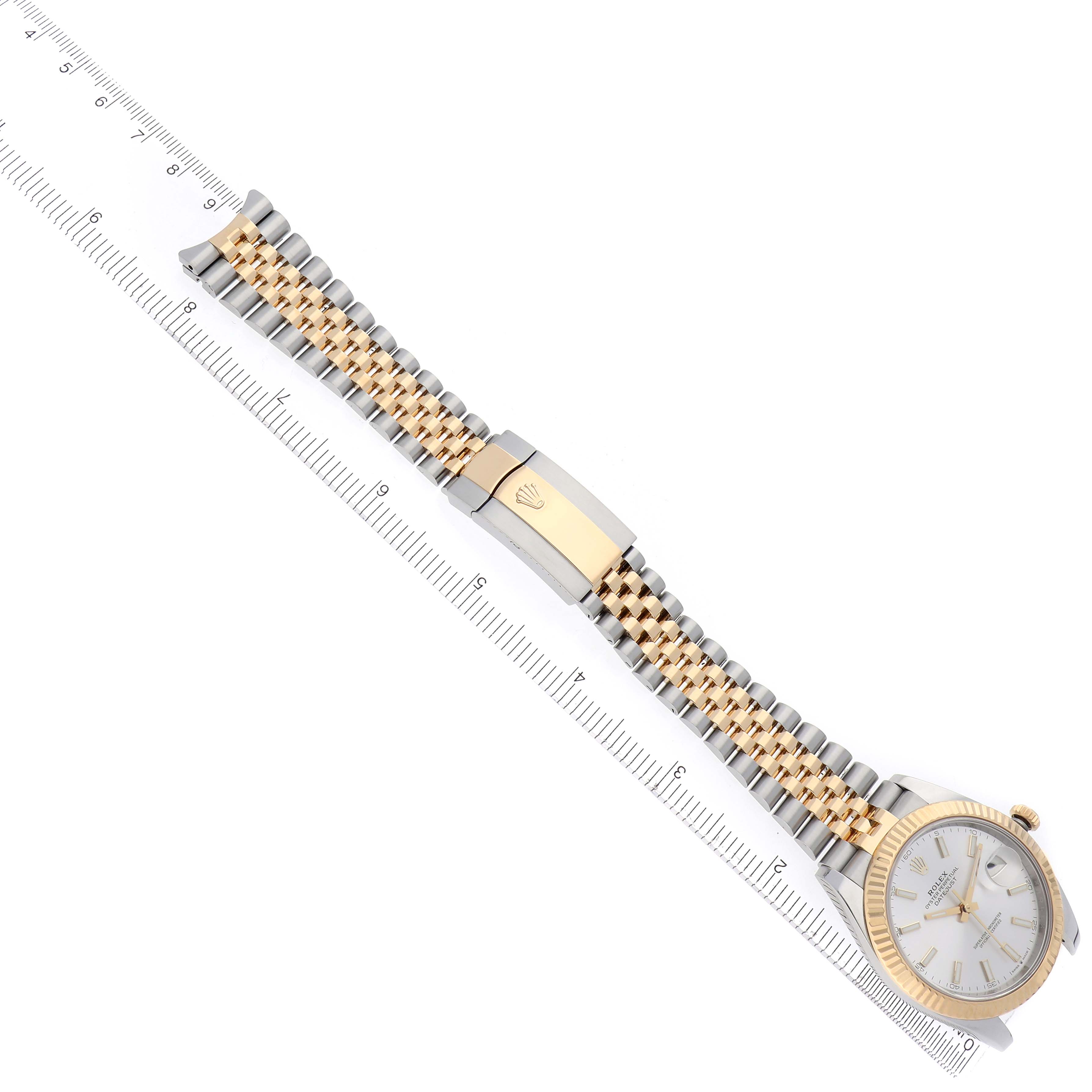 The Rolex Datejust 41 126333 Men
s Steel and Gold (two tone) Silver Dial 126333 Men
s Steel and Gold (two tone) Silver Dial watch is shown diagonally with its bracelet, clasp, and partial dial visible, alongside a ruler.