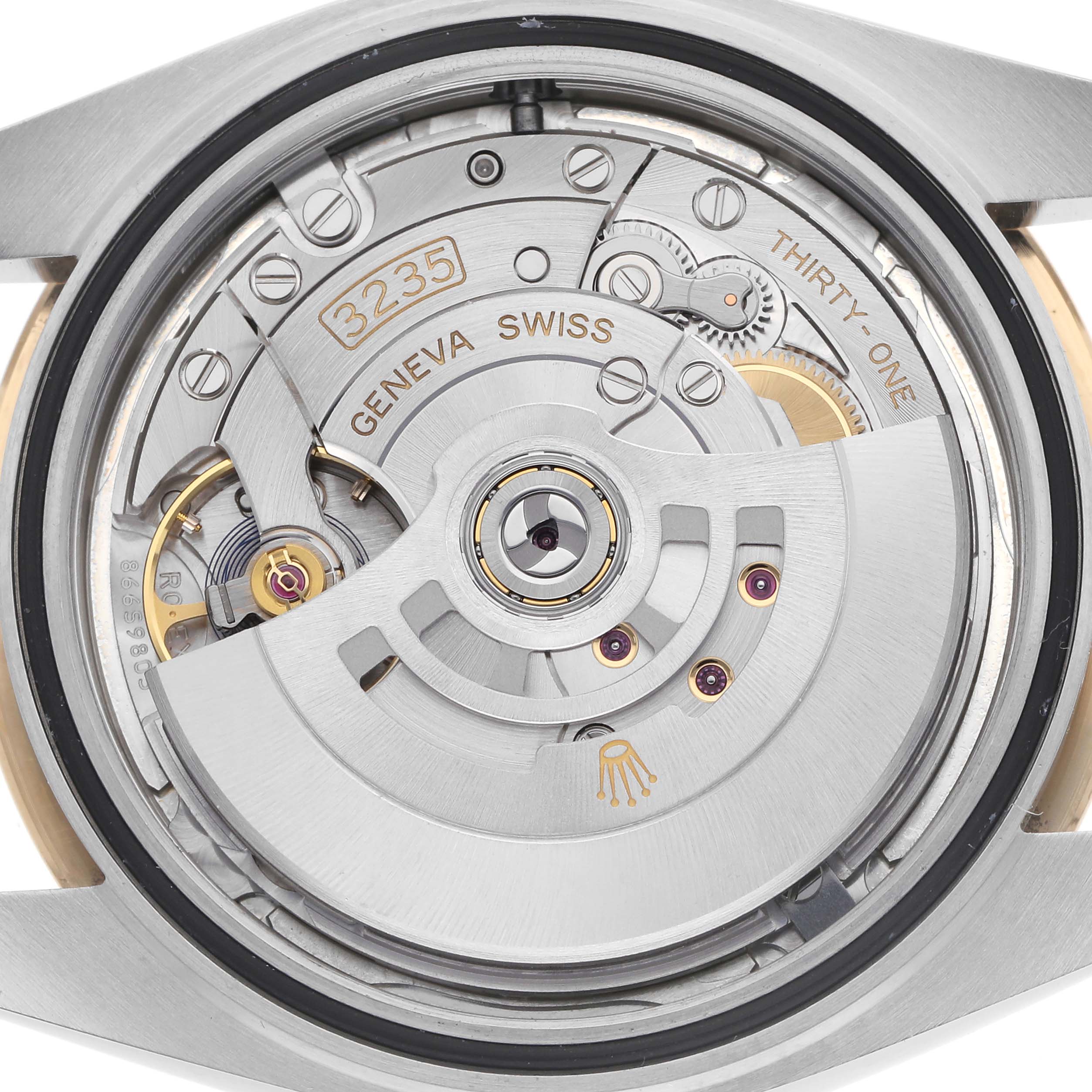 The image shows the movement of the Rolex Datejust 41 126333 Men
s Steel and Gold (two tone) Silver Dial 126333 Men
s Steel and Gold (two tone) Silver Dial watch from a back angle, highlighting its intricate mechanical parts.