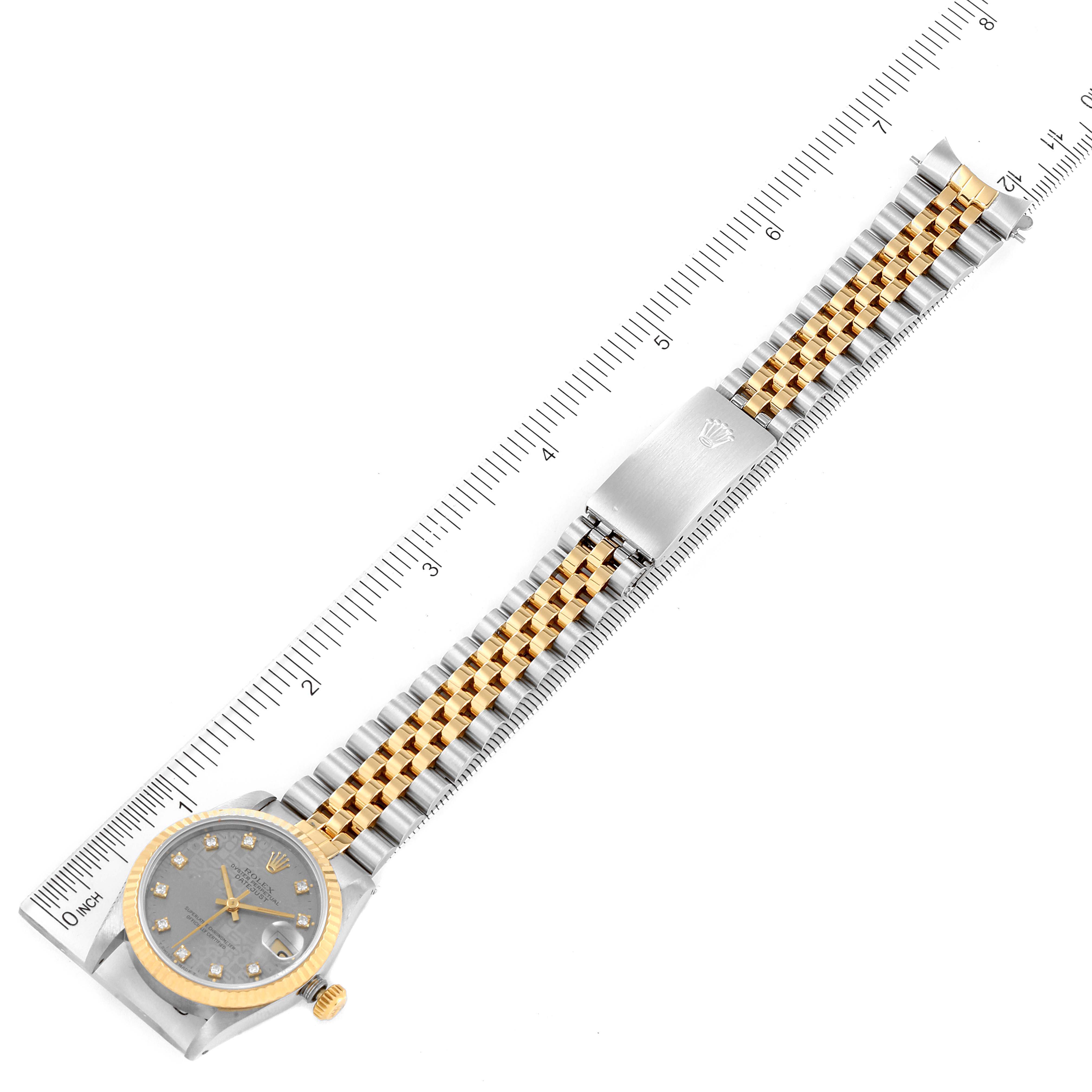The image shows a Rolex Mid-Size 68273 Women's Steel and Gold (two tone) Grey Dial 68273 Women's Steel and Gold (two tone) Grey Dial watch with a two-tone bracelet, a silver dial, and a measurement ruler for size reference.