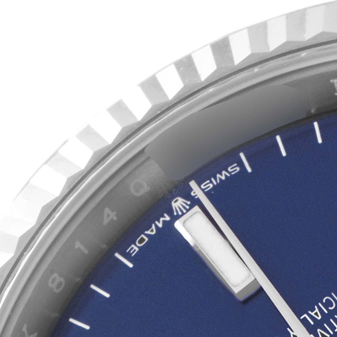 This close-up image of the Rolex Datejust 126234 Men's Stainless Steel Blue Dial 126234 Men's Stainless Steel Blue Dial watch shows its fluted bezel and a portion of the dial with the "Swiss Made" text.