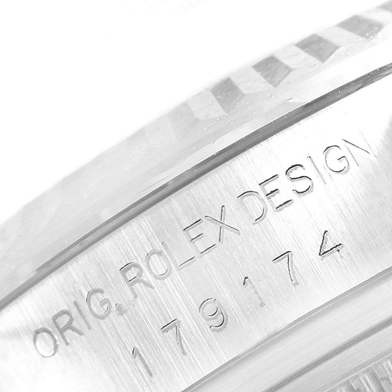 The image shows a close-up of the side of the case of a Rolex Datejust 179174 Women
s Stainless Steel Mother of Pearl Dial 179174 Women
s Stainless Steel Mother of Pearl Dial, focusing on the model number and "ORIG ROLEX DESIGN" engraving.