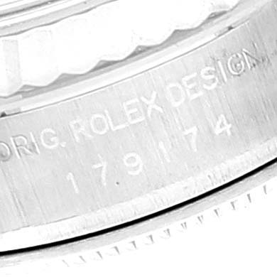 This image shows a close-up of a Rolex Datejust 179174 Women's Stainless Steel Pink Dial 179174 Women's Stainless Steel Pink Dial's case edge with engraved text including "ORIG. ROLEX DESIGN" and the model number "179174".