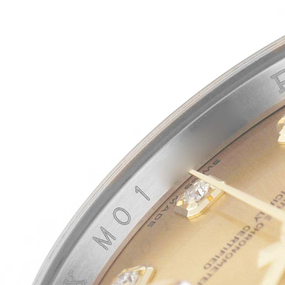 The image shows a close-up of the Rolex Datejust 116233 Men's Steel and Gold (two tone) Champagne Dial model's dial and bezel, highlighting diamond markers and partial inscriptions.