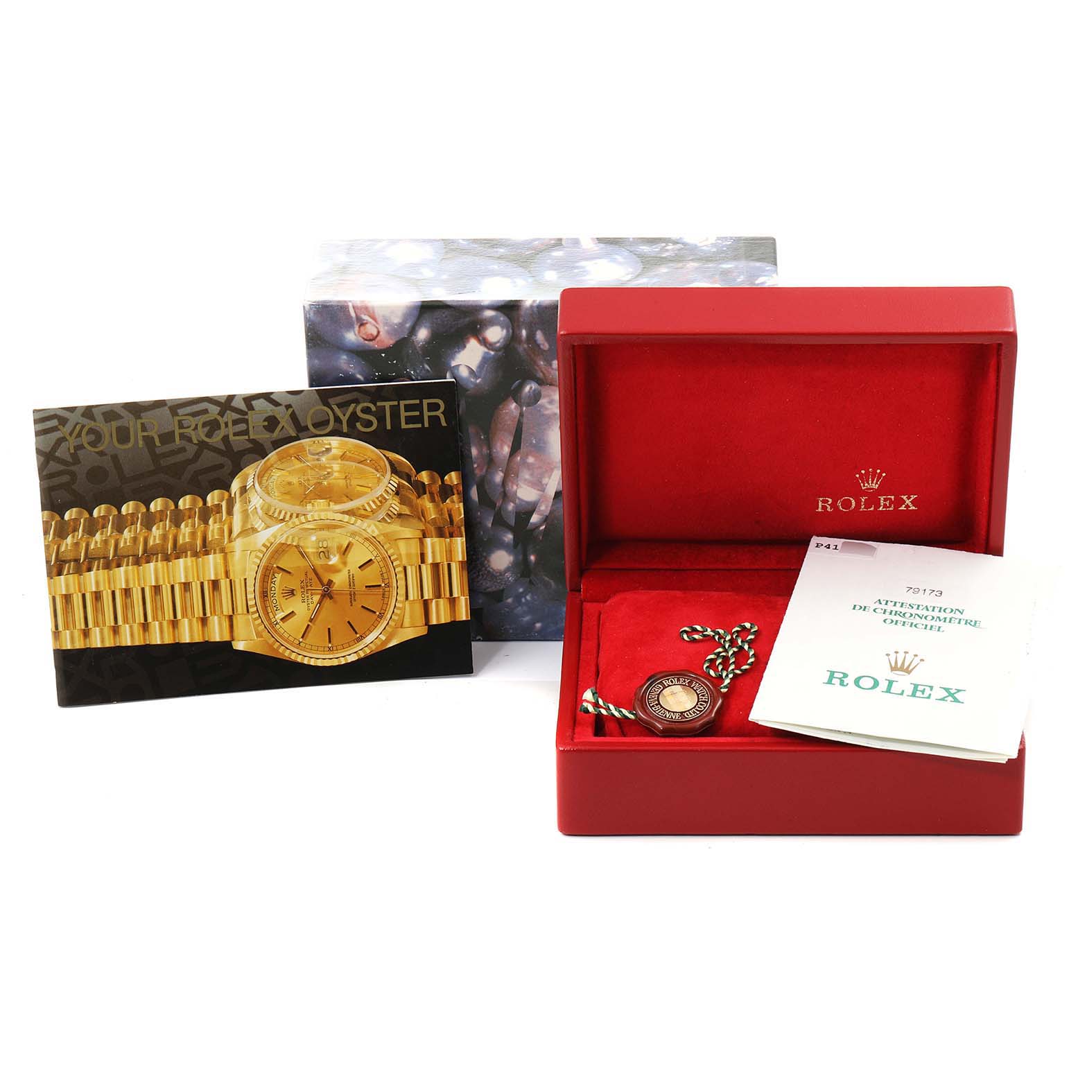 The image shows accessories for a Rolex Datejust 79173 Women
s Steel and Gold (two tone) Black Dial 79173 Women
s Steel and Gold (two tone) Black Dial, including a box, booklet, and tag, all captured from a front angle.