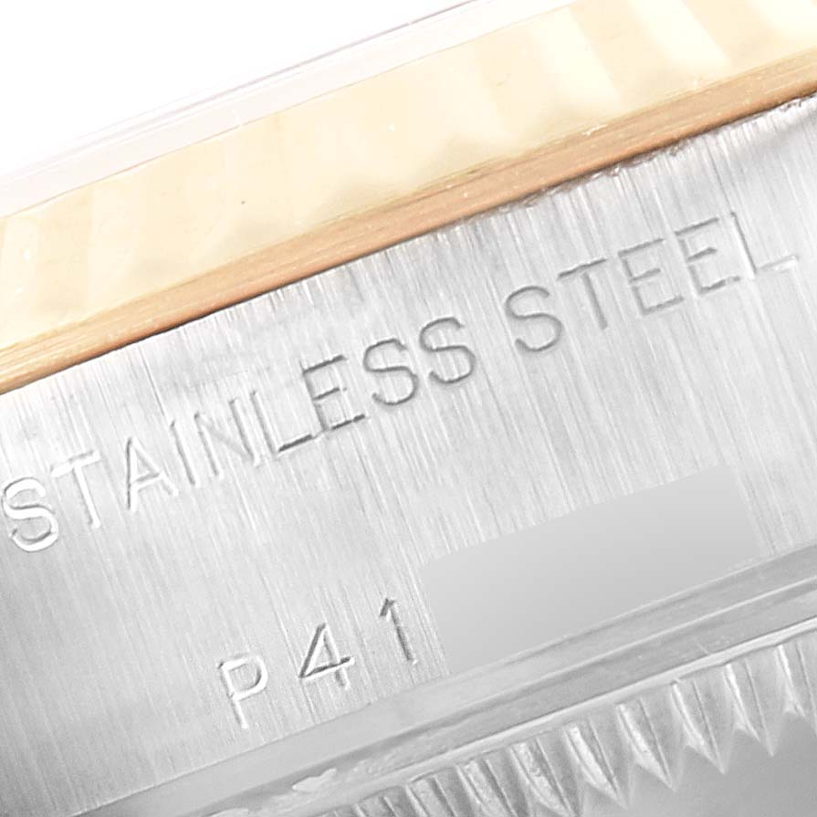 This close-up image shows the stainless steel text and part of the fluted bezel of a Rolex Datejust 79173 Women
s Steel and Gold (two tone) Black Dial 79173 Women
s Steel and Gold (two tone) Black Dial model.