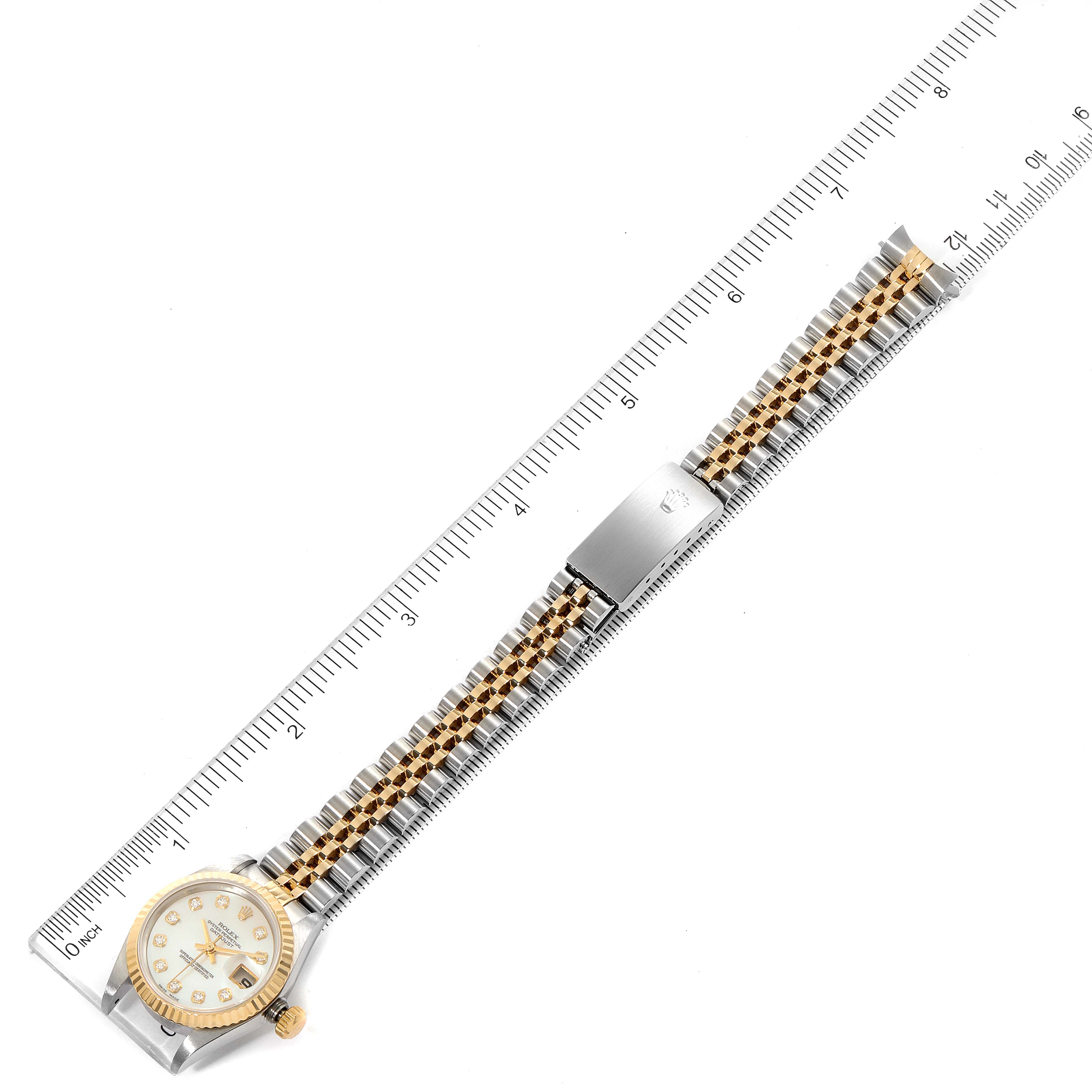 This image shows a top-down view of a Rolex Datejust 69173 Women
s Steel and Gold (two tone) Mother of Pearl Dial 69173 Women
s Steel and Gold (two tone) Mother of Pearl Dial watch, including its face, bezel, and two-tone bracelet, alongside a ruler for scale.