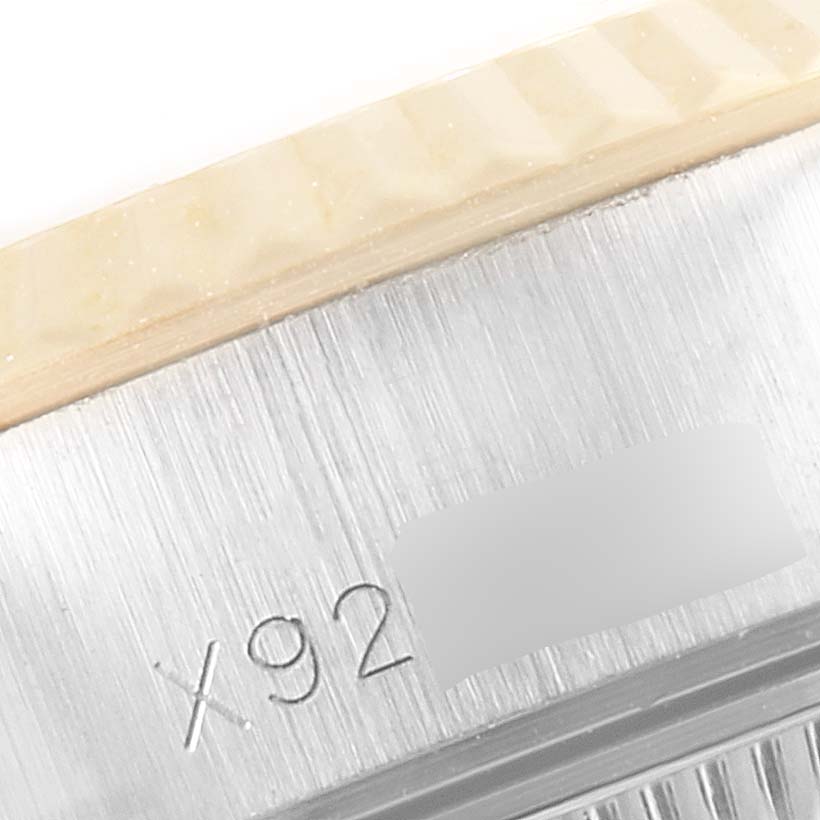 The image shows a close-up of the serial number engraving on the side of a Rolex Datejust 69173 Women
s Steel and Gold (two tone) Silver Dial 69173 Women
s Steel and Gold (two tone) Silver Dial watch case.