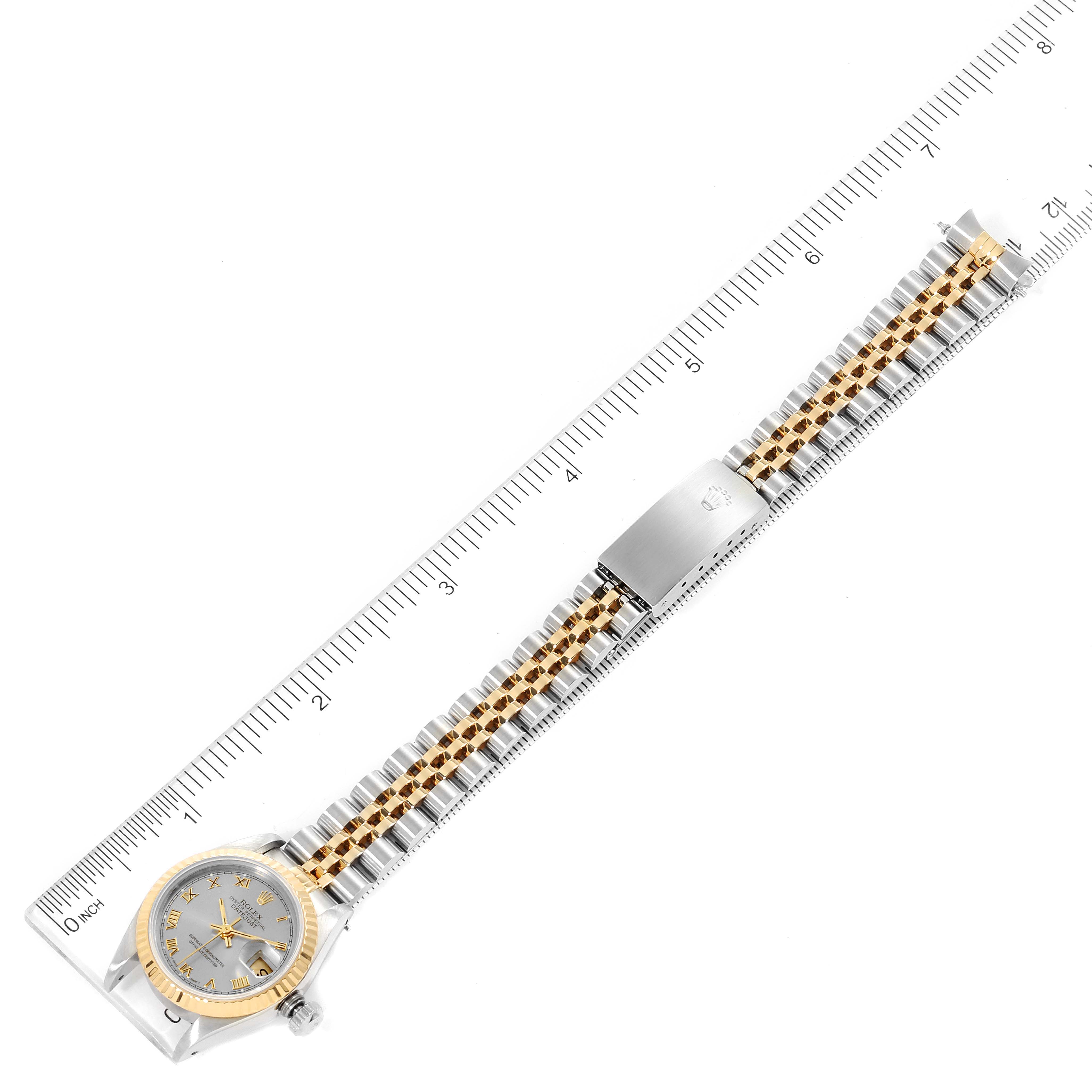 The image shows a Rolex Datejust 69173 Women
s Steel and Gold (two tone) Silver Dial 69173 Women
s Steel and Gold (two tone) Silver Dial watch from a top-down angle, displaying the dial, case, and full bracelet.