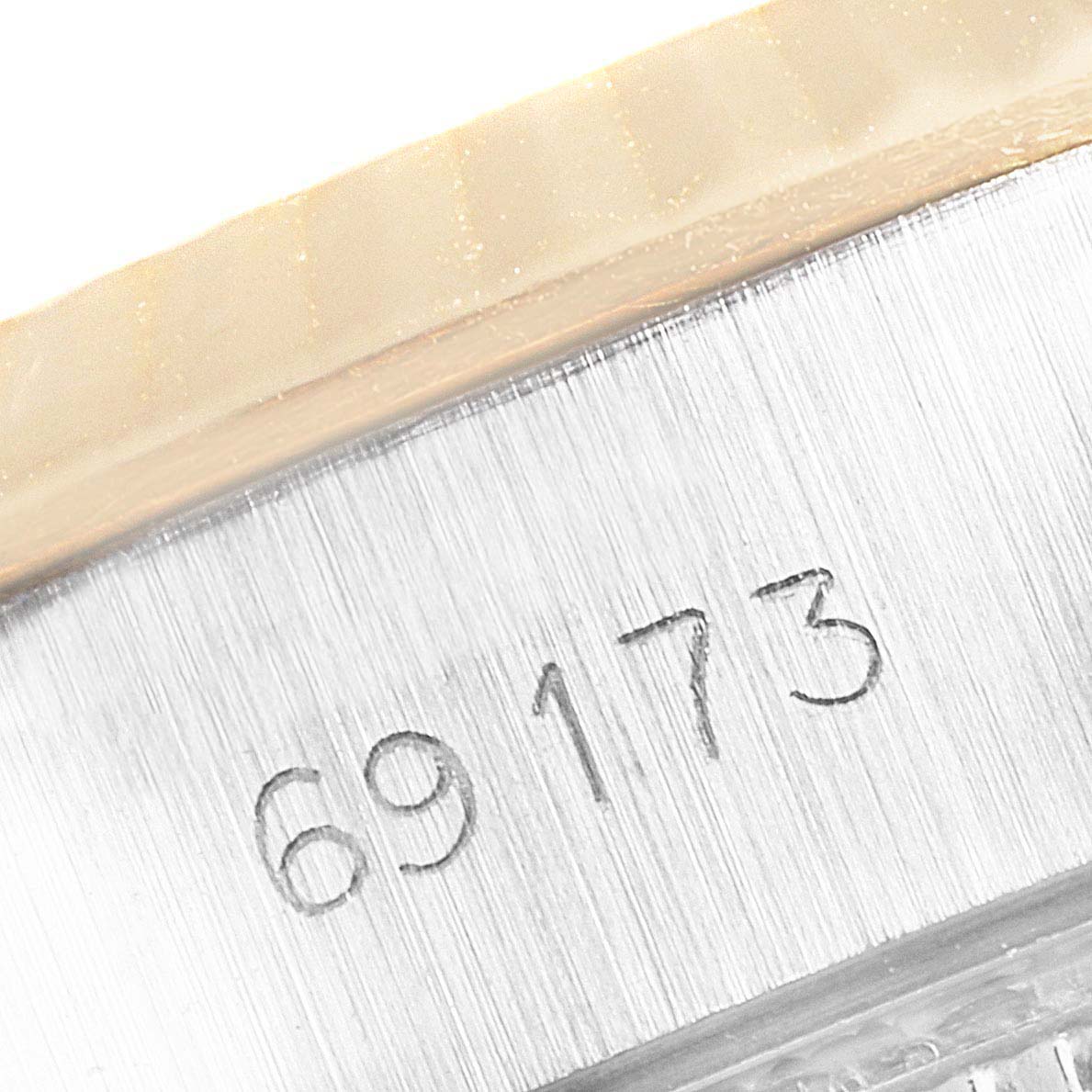 This close-up image of the Rolex Datejust 69173 Women
s Steel and Gold (two tone) Silver Dial 69173 Women
s Steel and Gold (two tone) Silver Dial shows the engraved model number "69173" on the watch case side.