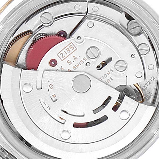 This image shows the internal movement mechanism of a Rolex Datejust 69173 Women
s Steel and Gold (two tone) Champagne Dial 69173 Women
s Steel and Gold (two tone) Champagne Dial watch, featuring the rotor and various gears.