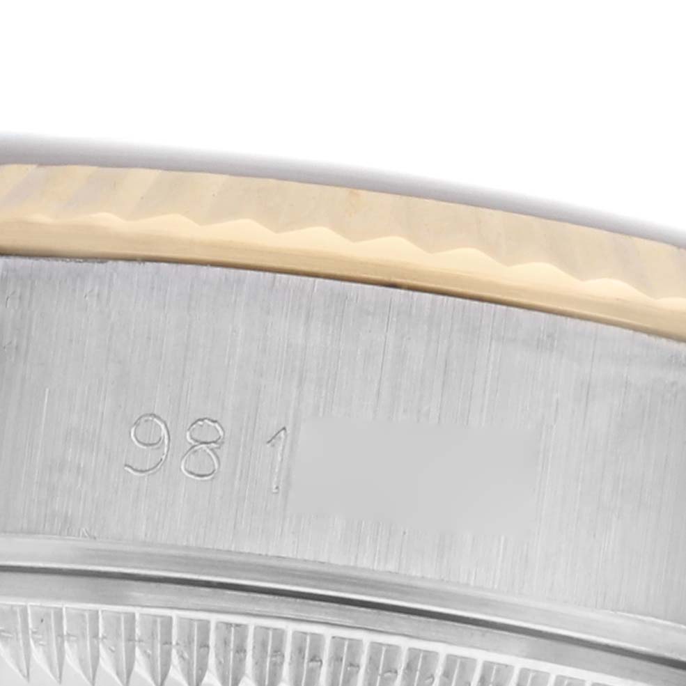 The image shows a close-up of the bezel and side of the Rolex Datejust 69173 Women's Steel and Gold (two tone) Blue Dial 69173 Women's Steel and Gold (two tone) Blue Dial watch, focusing on the engraved serial number.