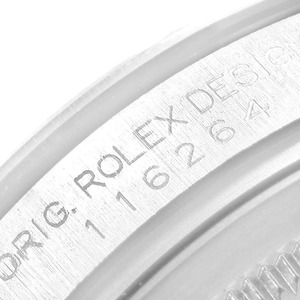 The image shows a close-up of the Rolex Turn-o-Graph 116264 Men's Stainless Steel Black Dial 116264 Men's Stainless Steel Black Dial model's engraved bezel, displaying part of the brand name and serial number.