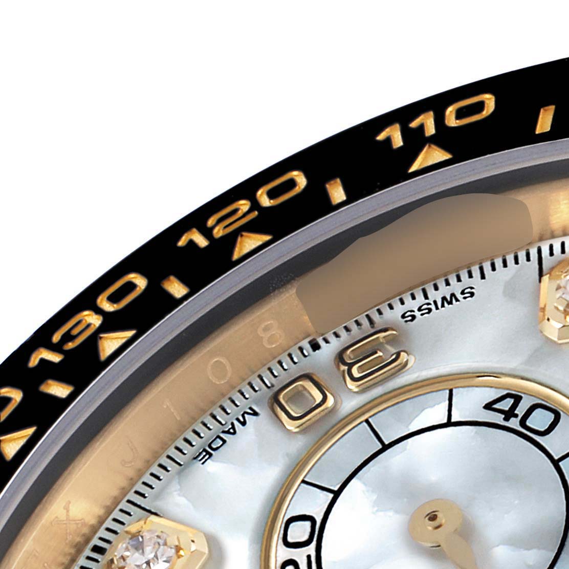 The image shows a close-up of the bezel and part of the dial on a Rolex Daytona 116518 Men's Yellow Gold Mother of Pearl Dial 116518 Men's Yellow Gold Mother of Pearl Dial watch, highlighting the tachymeter scale and part of the subdial.
