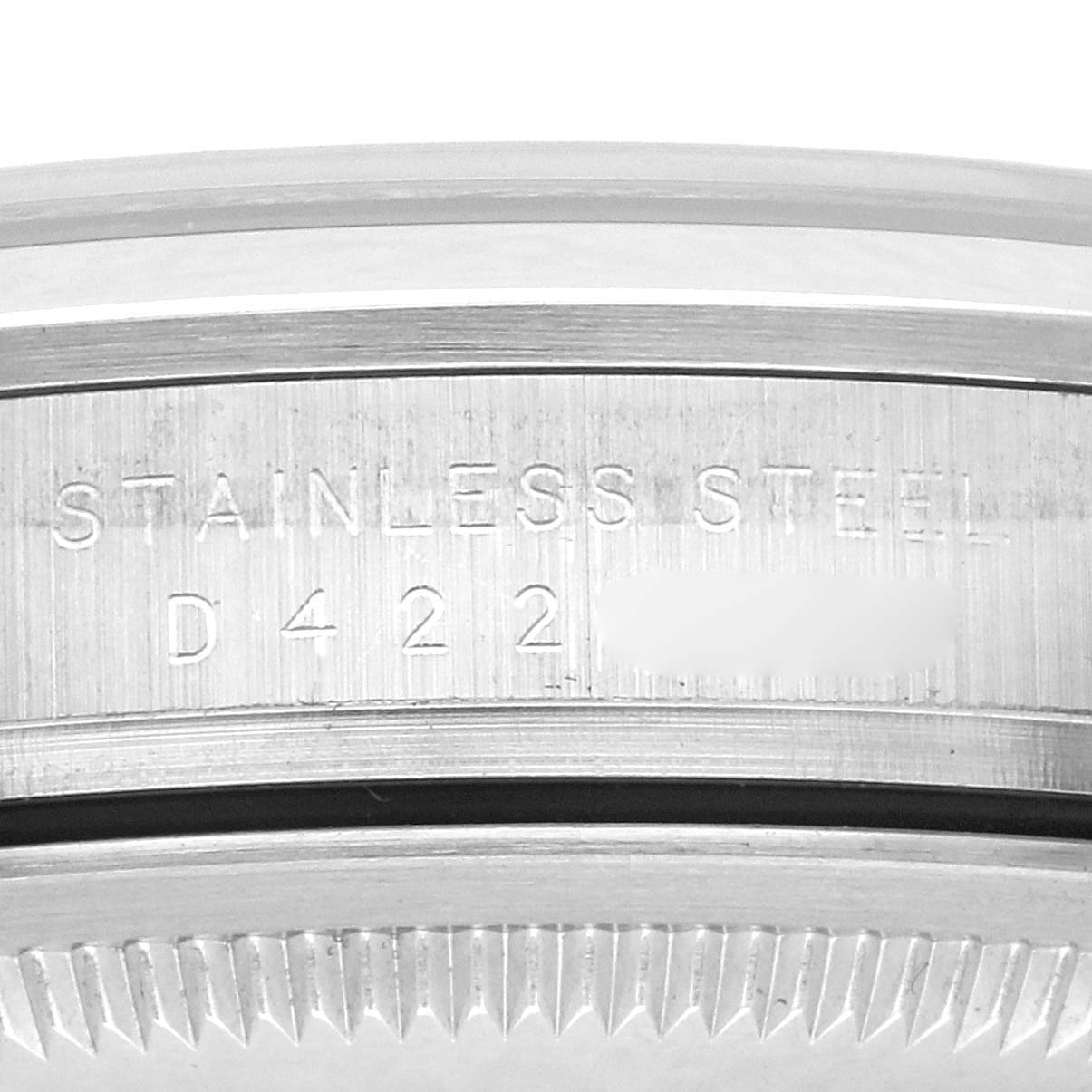 The image shows a close-up of the case back edge and part of the bezel, with "Stainless Steel" engraved, on a Rolex Explorer 114270 Men
s Stainless Steel Black Dial 114270 Men
s Stainless Steel Black Dial.