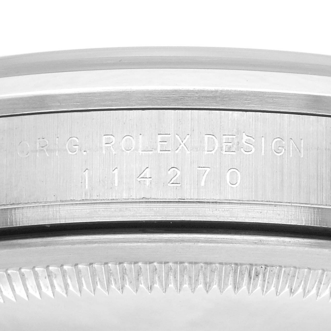 The image shows the engraved side of a Rolex Explorer 114270 Men
s Stainless Steel Black Dial 114270 Men
s Stainless Steel Black Dial watch, focusing on the case
s edge with the model number 114270.